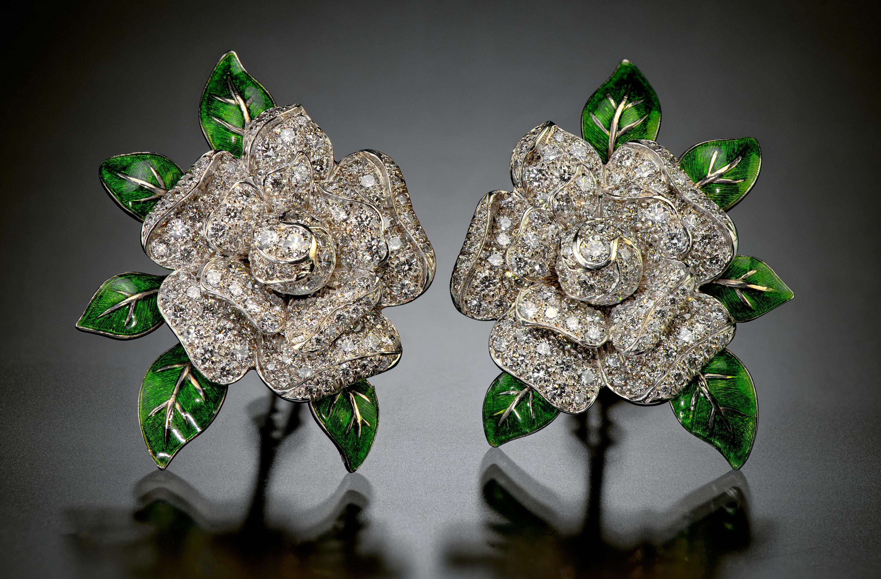 For over one hundred years, Oscar Heyman has been making exquisite jewelry by hand in their New York City studio. In these pleasing gardenia flowering ear clips, 263 round diamonds are set in platinum with green enamel accents. The first Heyman