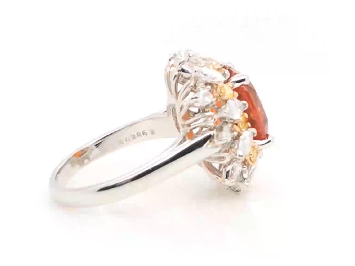 Oscar Heyman 18kt yellow gold and platinum ring with 6.04ct Ceylon Cushion Orange Sapphire (with GIA gem report) and a sunburst-style setting of 10 Marquise Diamonds (1.00cts), 10 Pear Shape Diamonds (0.40cts), and 10 Fancy Golden Yellow Diamonds