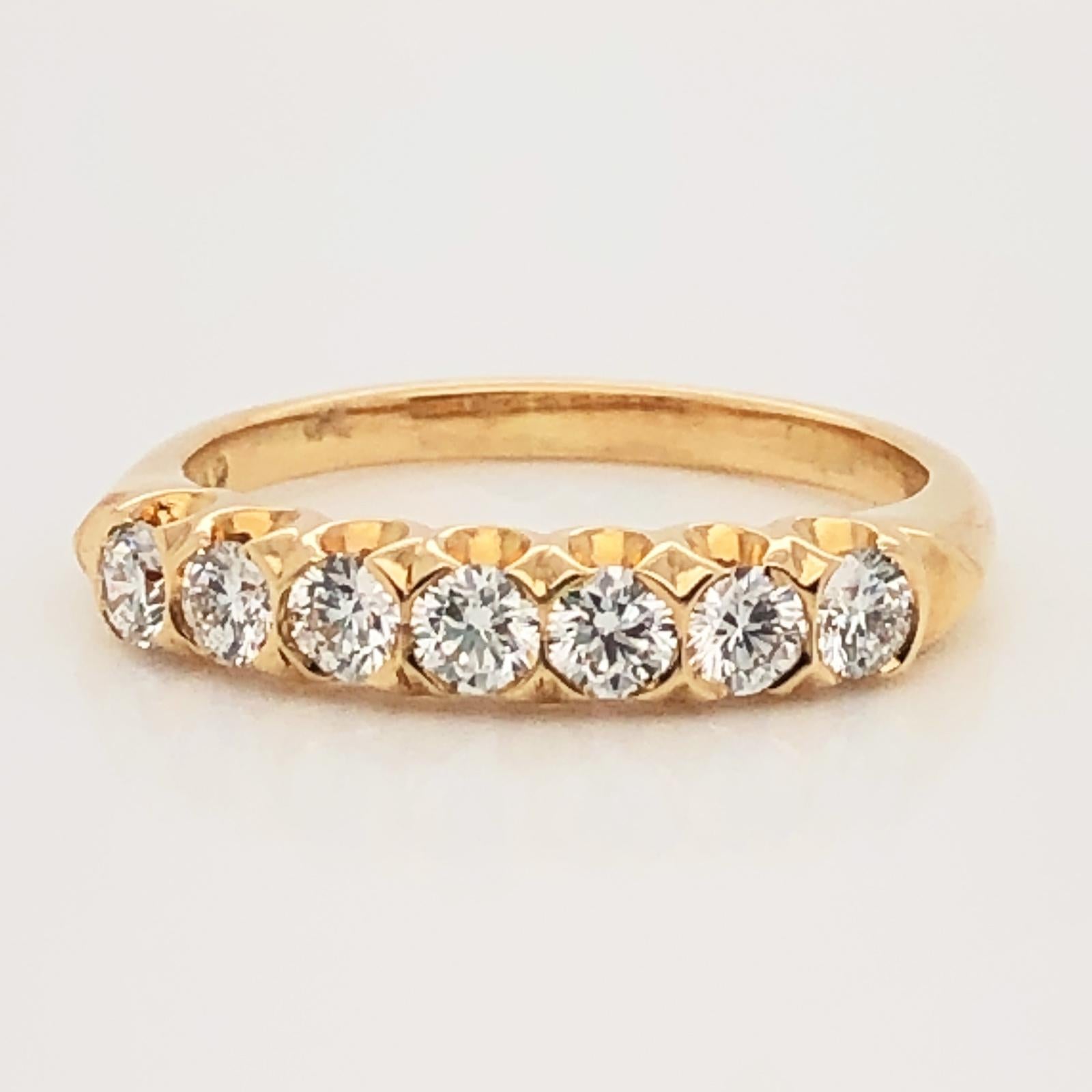 Oscar Heyman 18kt yellow gold diamond partway wedding band ring contains 7 Round Diamonds (F-G/ VS+ quality) weighing 0.55cts. It is 3mm wide and stamped with the makers mark, 18K, and serial number W1149. 

Size 6. Can be re-sized between a 5 -