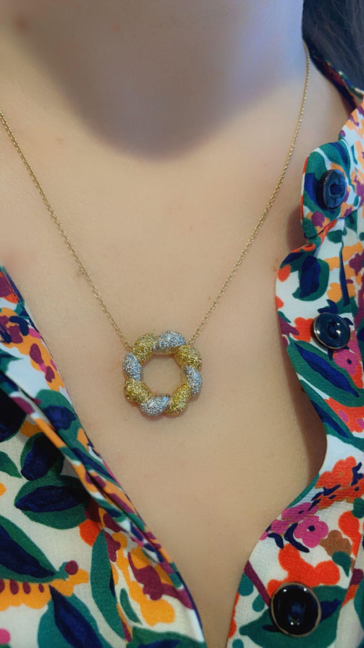 Oscar Heyman's elegant pendant necklace contains a braided fancy golden yellow and white diamond eternity loop, with 1.99tcw of diamonds. It is on a light weight 18k yellow gold chain that is ~18''. All white diamonds used are F/G-VS quality and the