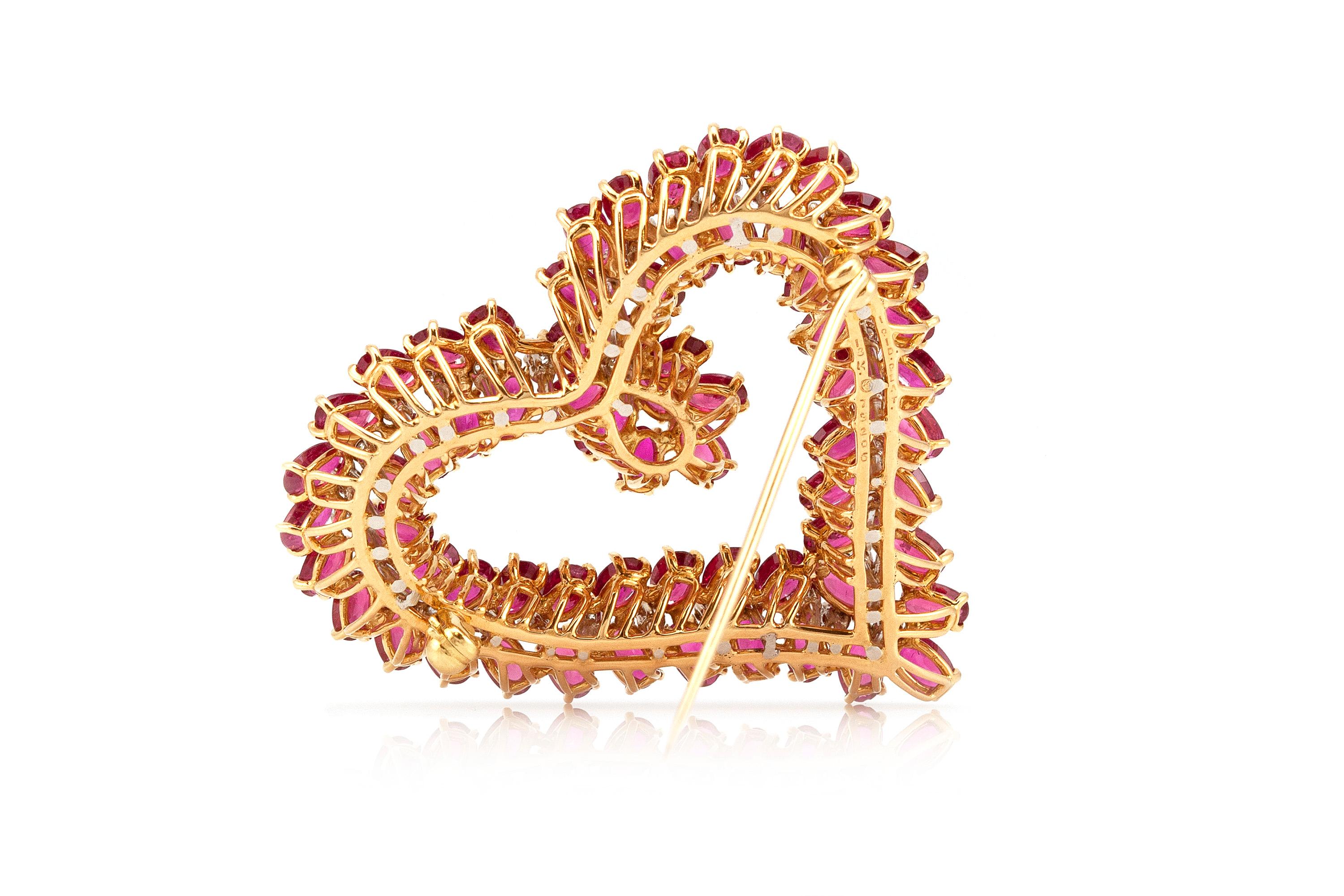 Beautiful Oscar Heyman heart shaped brooch finely crafted in 18K yellow gold and platinum.
The centering line of 35 round diamonds weigh approximately 0.92 ct.
Diamonds color : H-I
Diamonds clarity: VS
The surrounding 66 oval shaped rubies weigh