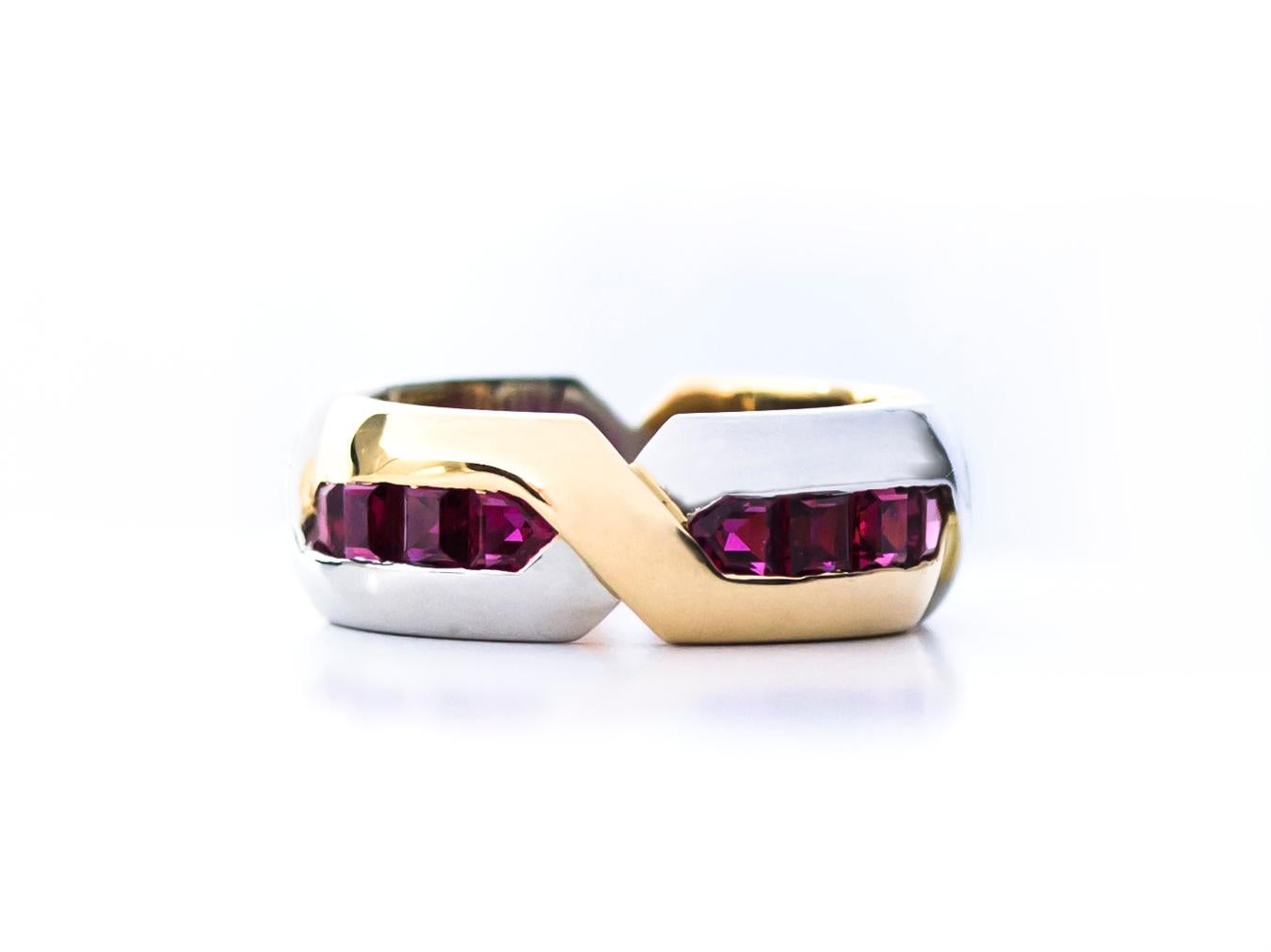 Oscar Heyman 18kt yellow gold and platinum ruby band ring contains 16 Square Rubies weighing 2.96cts. It is 7mm wide and stamped with the makers mark, 18K PLAT, and serial number M2842. 

Size 6.

Additional sizes are available. Also available with
