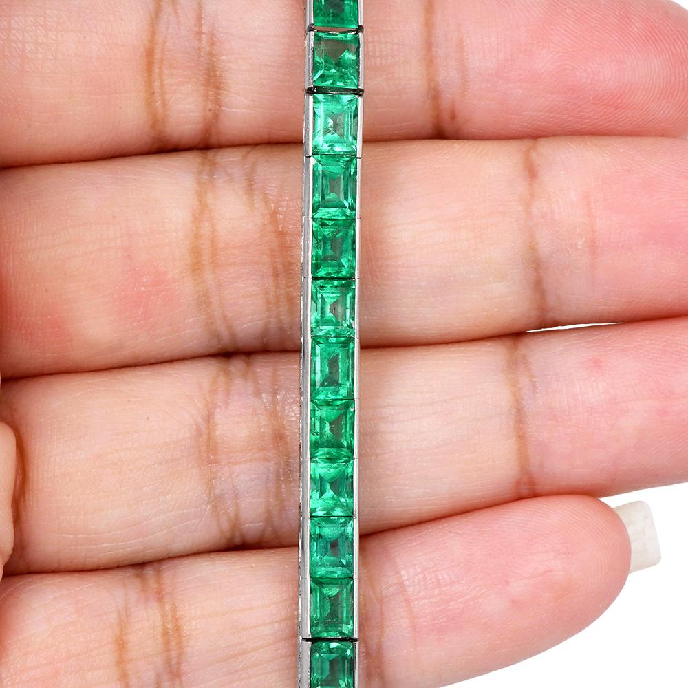 This vintage Oscar Hayman mid-century bracelet, crafted in 1949, is a testament to classic elegance and fine craftsmanship. It features a sumptuous line of 35 step-cut emeralds, each meticulously chosen for its vibrant hue and clarity, totaling a