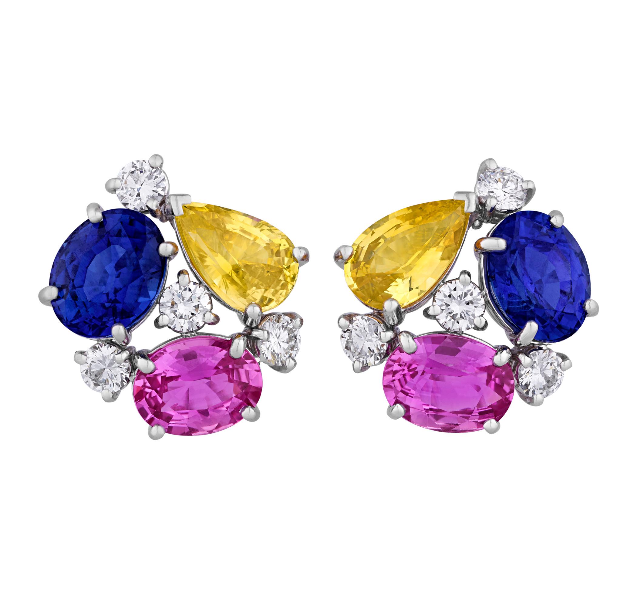 These unique and vibrant earrings by Oscar Heyman feature an artful arrangement of gemstones. They are expertly crafted from 2 oval cut blue sapphires totaling 6.57 carats, 2 oval cut pink sapphires totaling 4.04 carats, 2 pear cut yellow sapphires