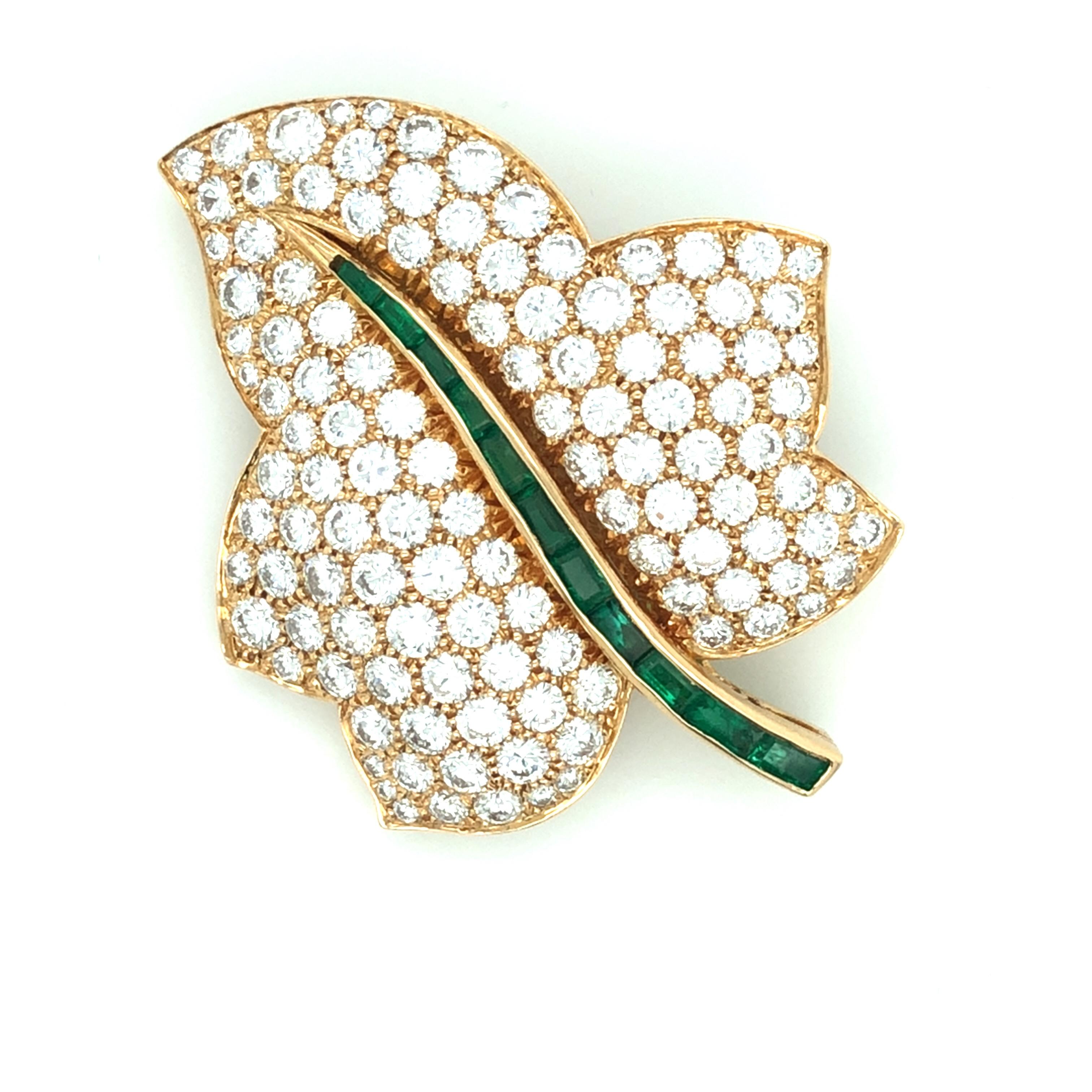 Oscar Heyman 18kt yellow gold and platinum maple leaf brooch contains 119 round diamonds weighing 6.60cts (F-G/VS+) and 11 baguette emeralds weighing 0.85cts. It is stamped with the makers mark, 18K, and serial number 74084.

Brooch measures 45mm in