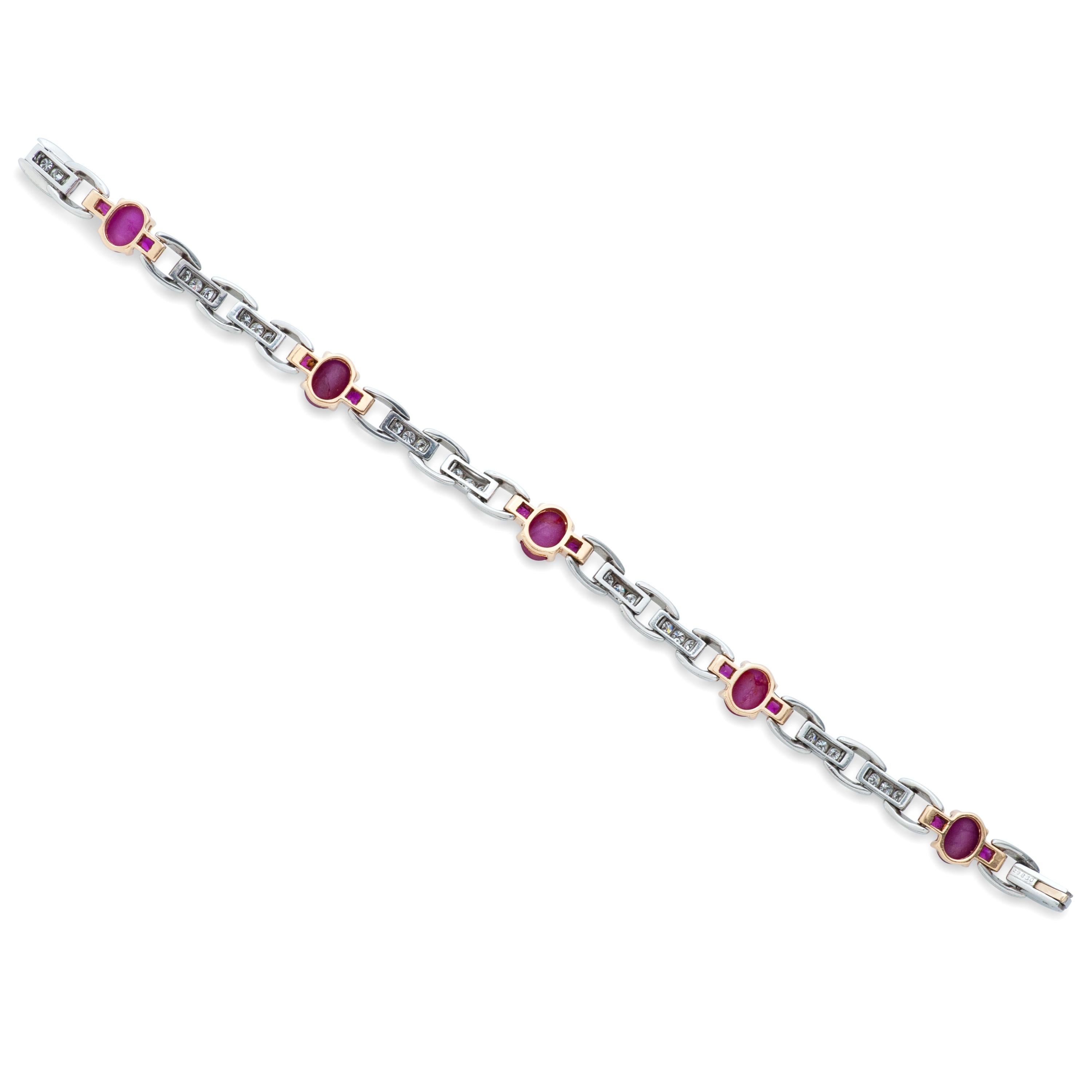 Oscar Heyman platinum and 18k yellow gold cabochon star ruby and diamond bracelet.  5 oval cabochon star rubies weighing approximately 6.25 carats are accented with 10 baguette rubies weighing 1.20ct and 30 round diamonds weighing 1.00 carat with G