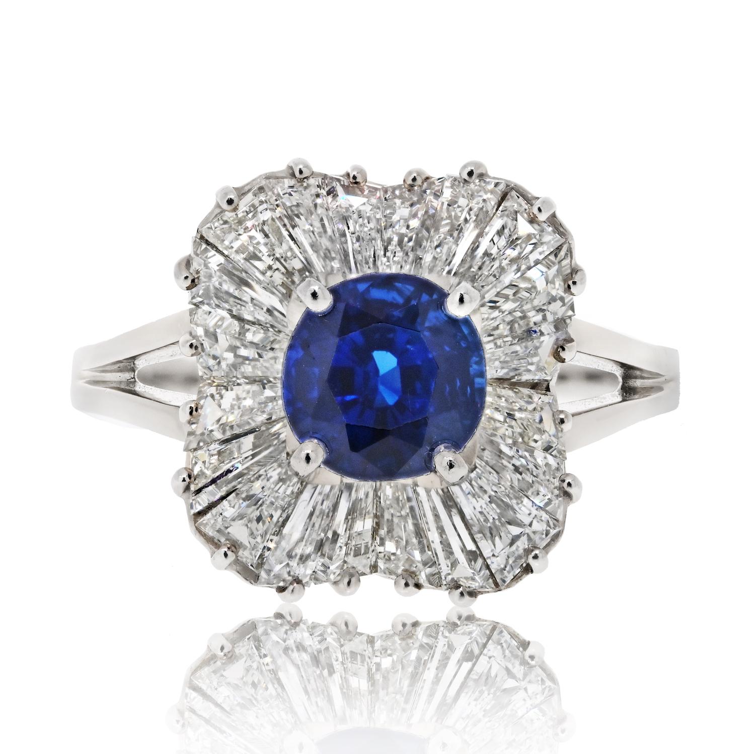 Elevate your style with the timeless elegance of this Oscar Heyman ballerina ring. The focal point is a stunning 1.99-carat cushion-cut sapphire that exudes deep, captivating blue hues. Surrounding the sapphire are 2.58 carats of baguette-cut