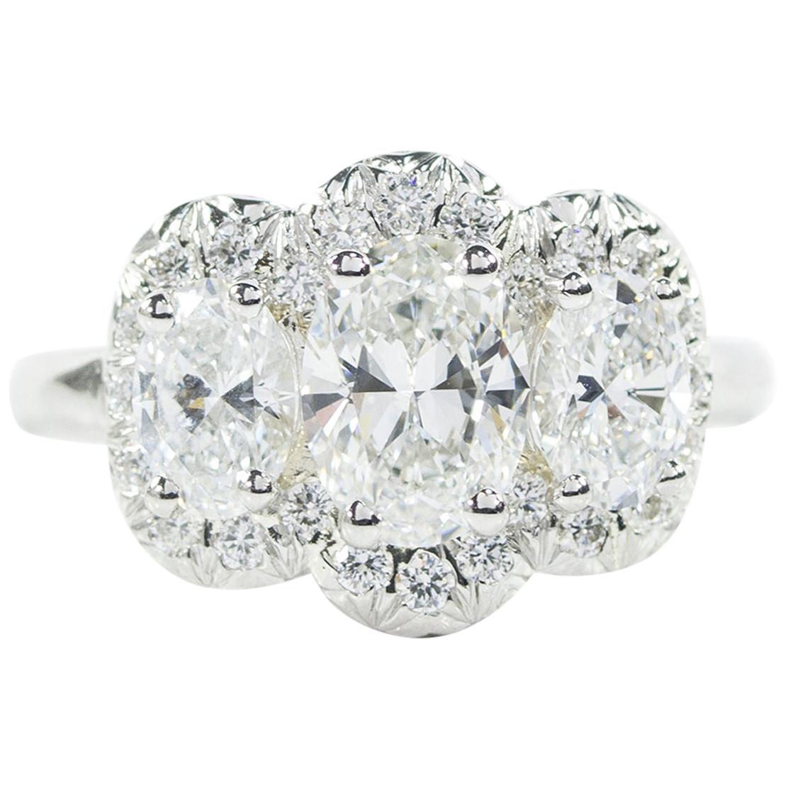 Oscar Heyman Platinum GIA Certified Oval Diamond with Halo Three-Stone Ring For Sale