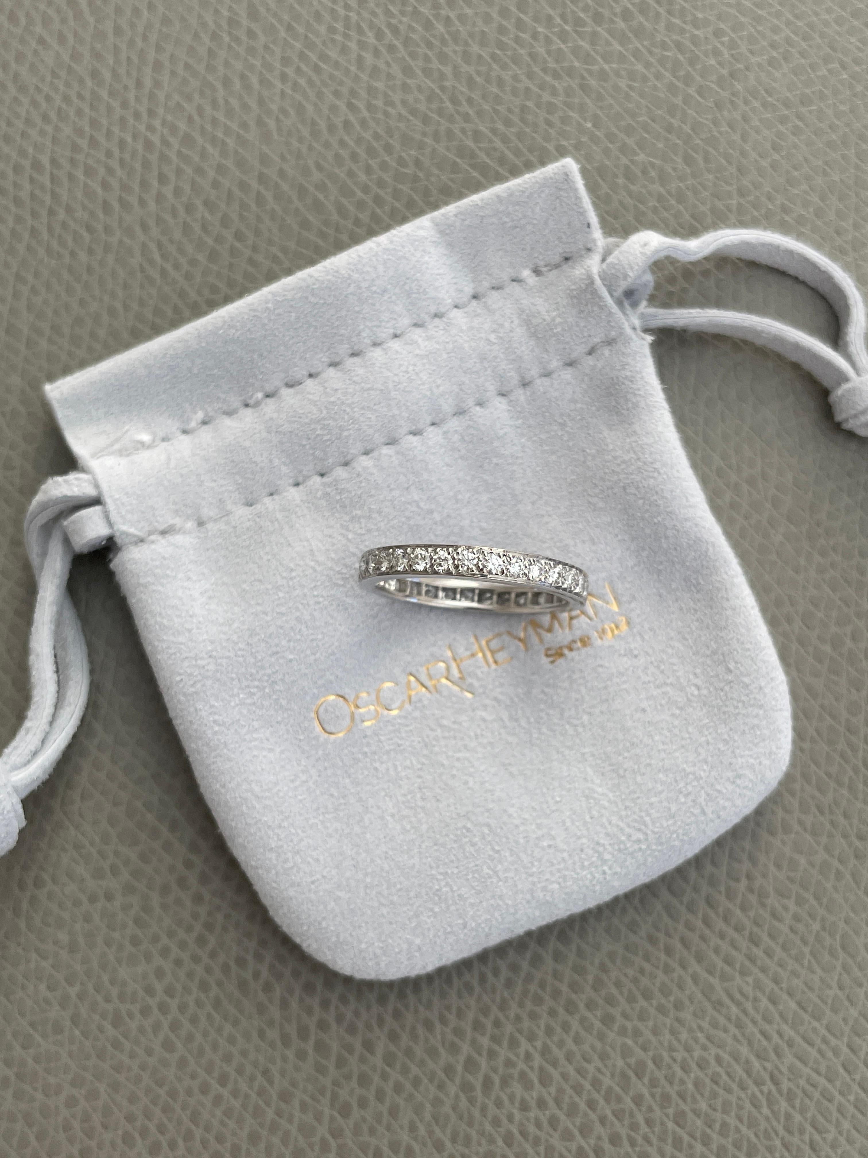 Oscar Heyman platinum bead set diamond band ring contains 31 Round Diamonds (F-G/ VS+ quality) weighing 0.63 cts. The diamonds extend around the whole ring. The ring is 2.5mm wide and is stamped with the makers mark, PLAT, and serial number W709. 