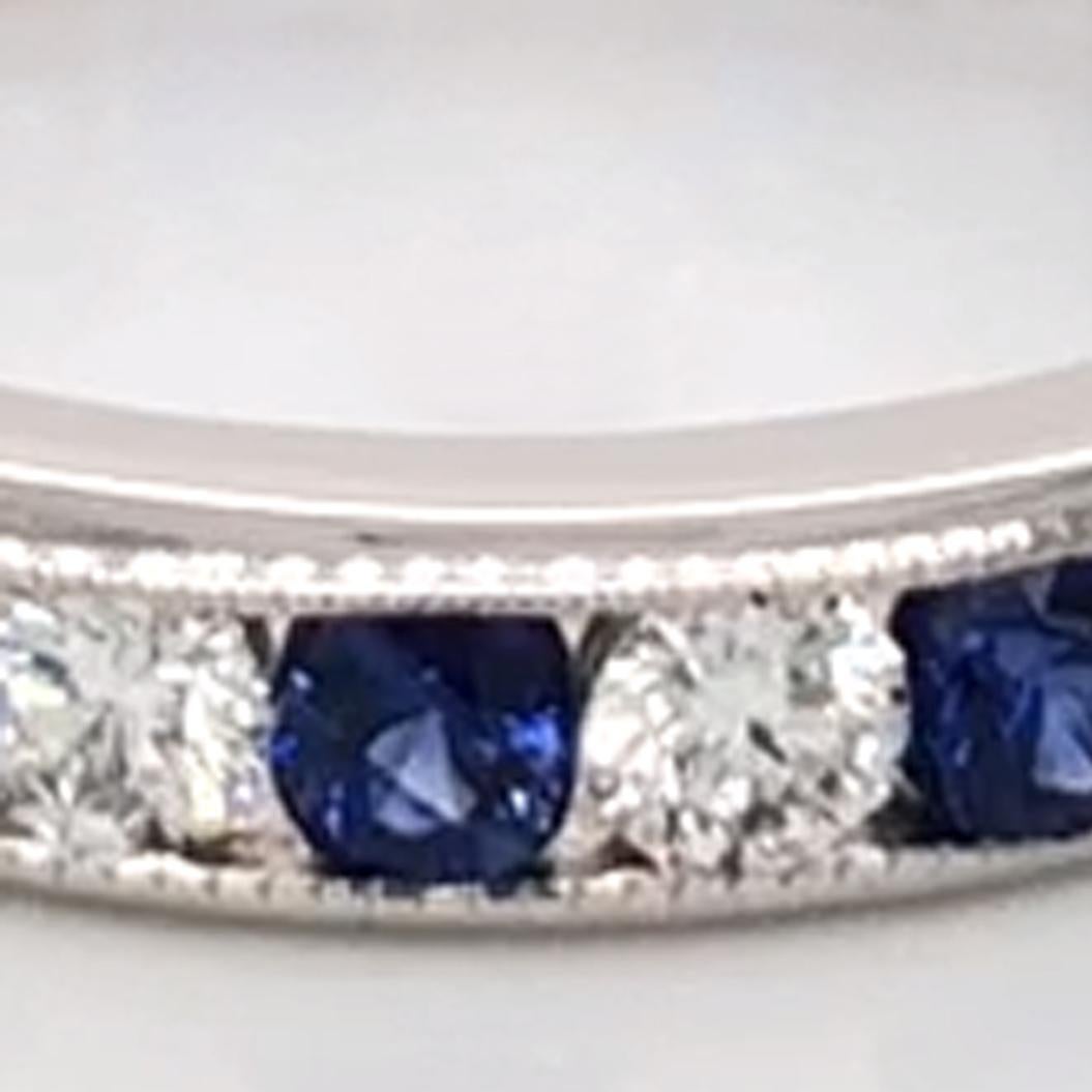 Oscar Heyman platinum sapphire and diamond wedding band ring contains 13 Round Diamonds (F-G/ VS+ quality) weighing 0.83cts and 13 Round Sapphires weighing 1.26cts that are channel set. It is 3.5mm wide and stamped with the makers mark, IRID PLAT,