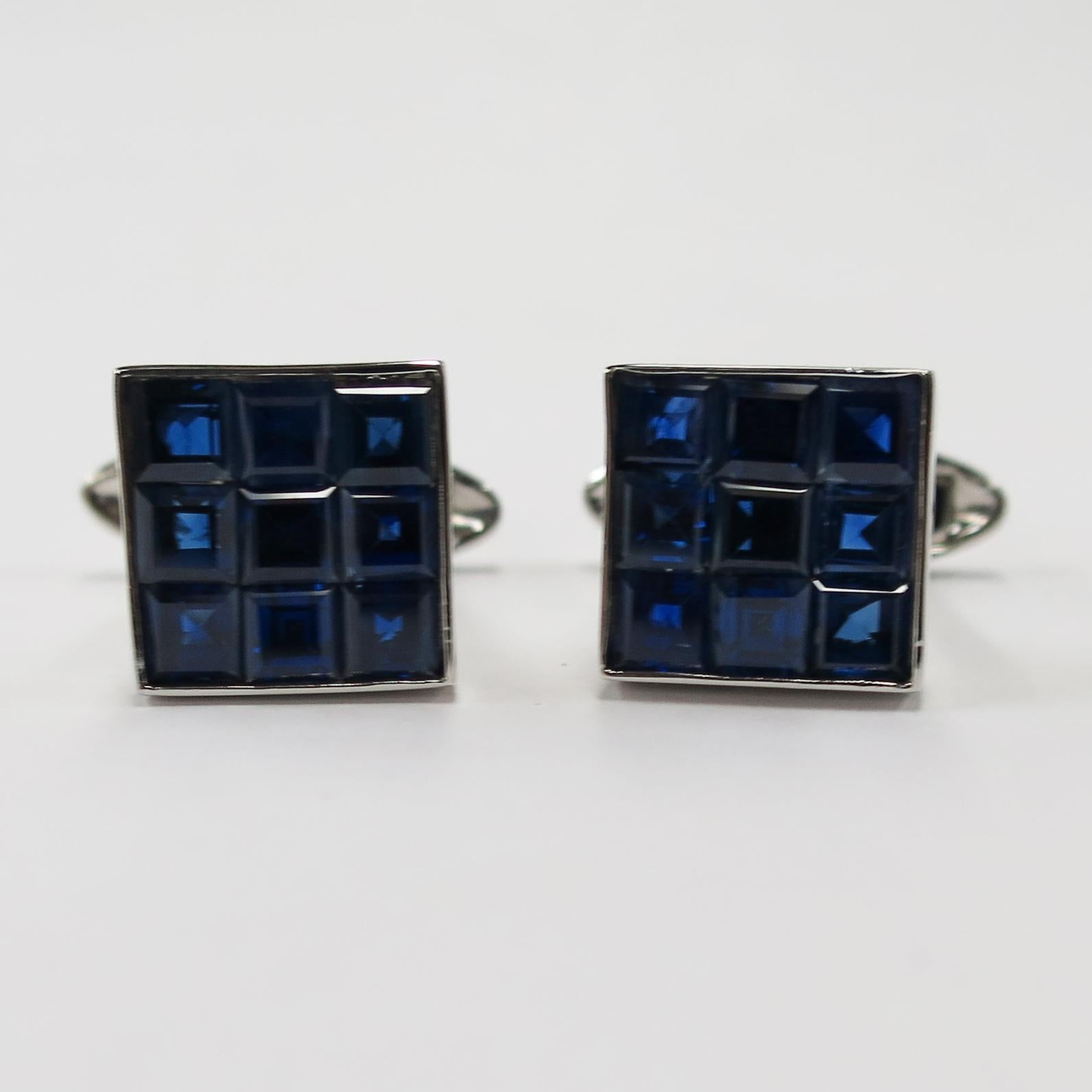 Oscar Heyman platinum cufflinks with 6.90cts of square sapphires. Invisibly set refers to the fact that there is no metal holding each stone in place. Each stone is hand-grooved beneath the girdle by an in-house lapidary in order to be slid onto a