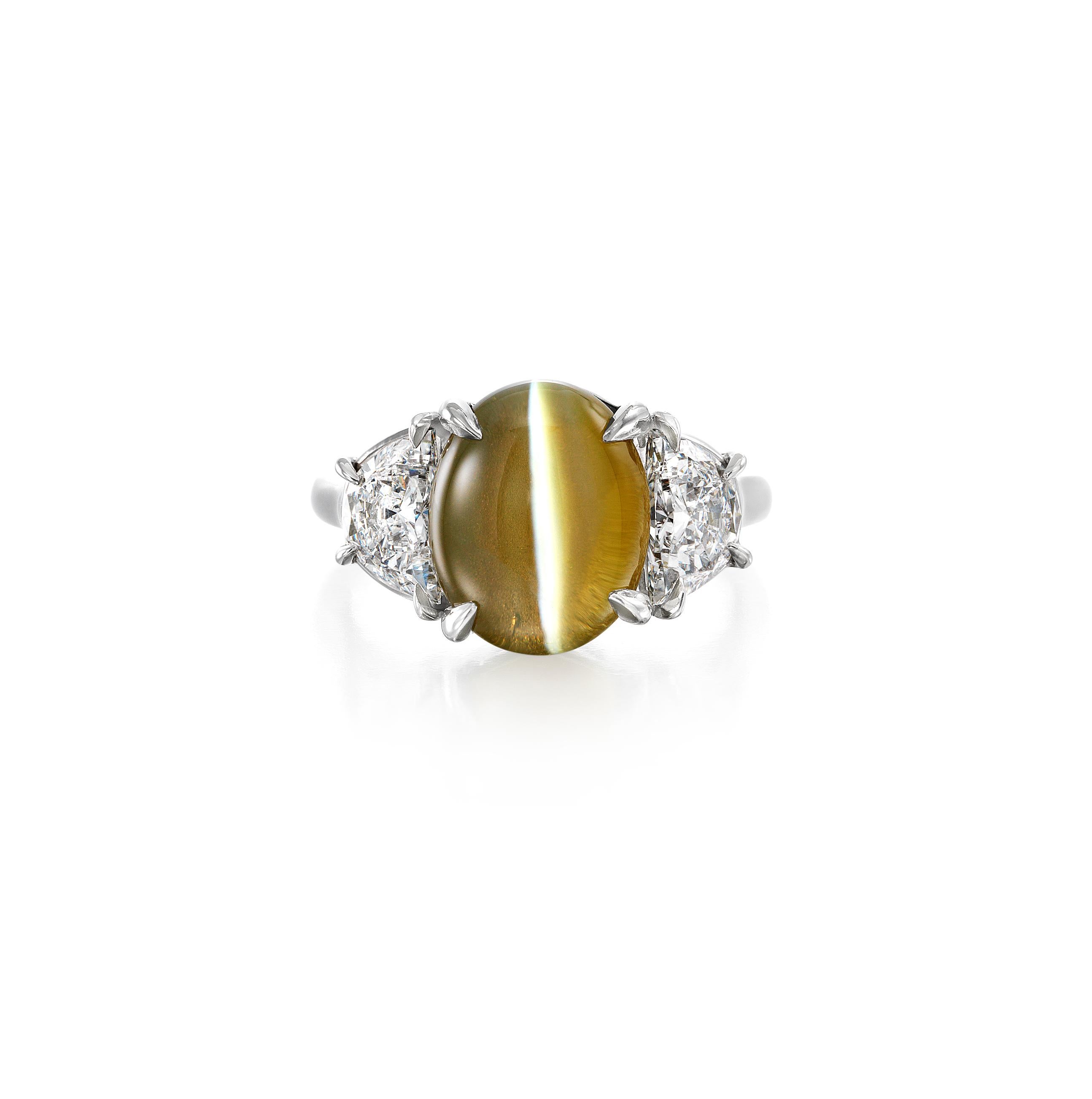 Oscar Heyman platinum ring containing 7.03ct Ceylon Cat's-Eye Chrysoberyl and two Halfmoon Diamonds with a total weight of 1.29cts (no gem report, F-G color, VS-SI1 clarity). Ring is stamped with the OH trademark, unique serial number 302281 and