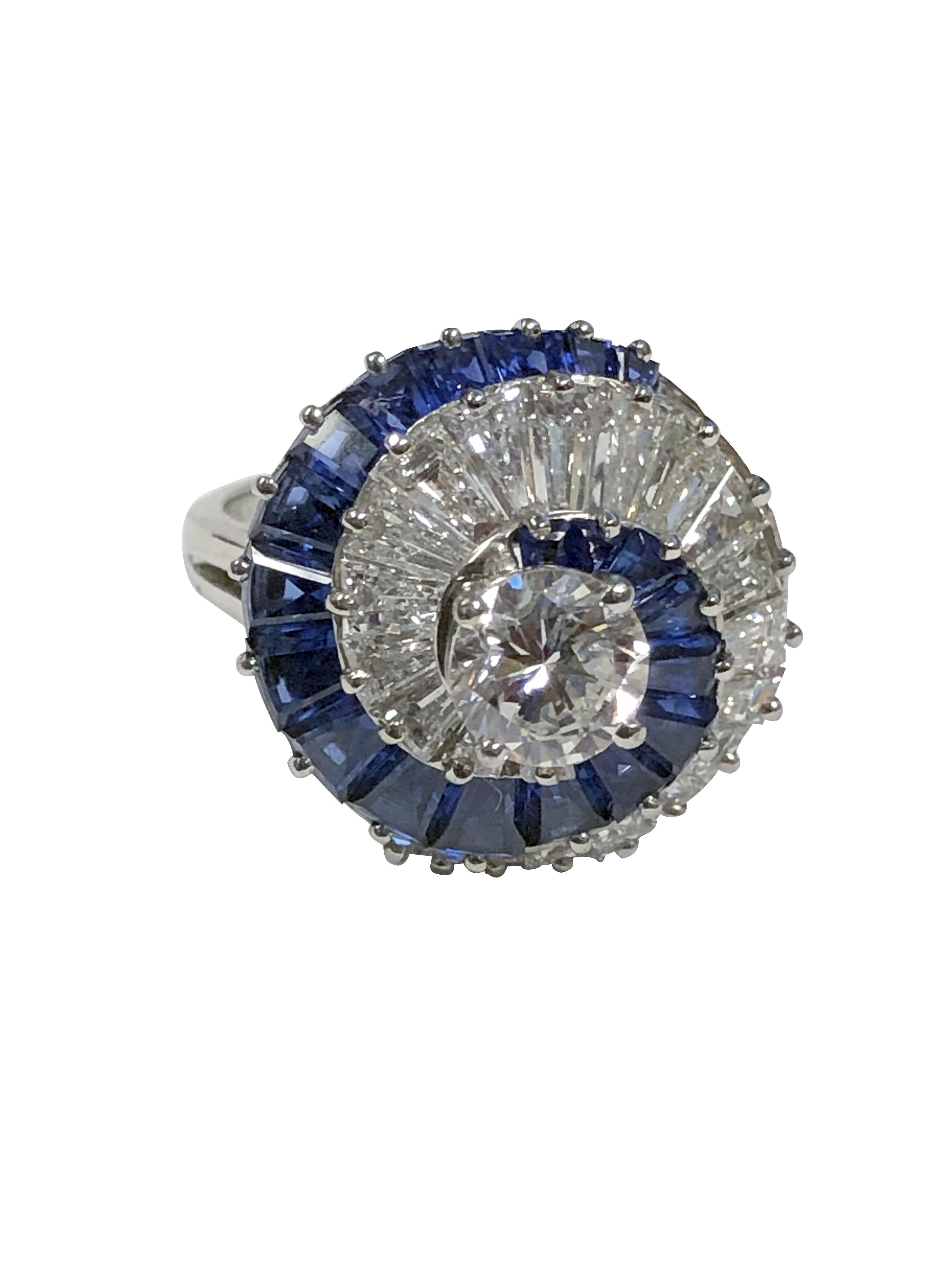 Circa 1980 Oscar Heyman Platinum, Diamond and Sapphire Swirl Ring, this Famous Design created by Oscar Heyman, the top measures 5/8 inch in diameter and is centrally set with a .87 carat Round Brilliant cut Diamond surrounded by 1.78 Carats of