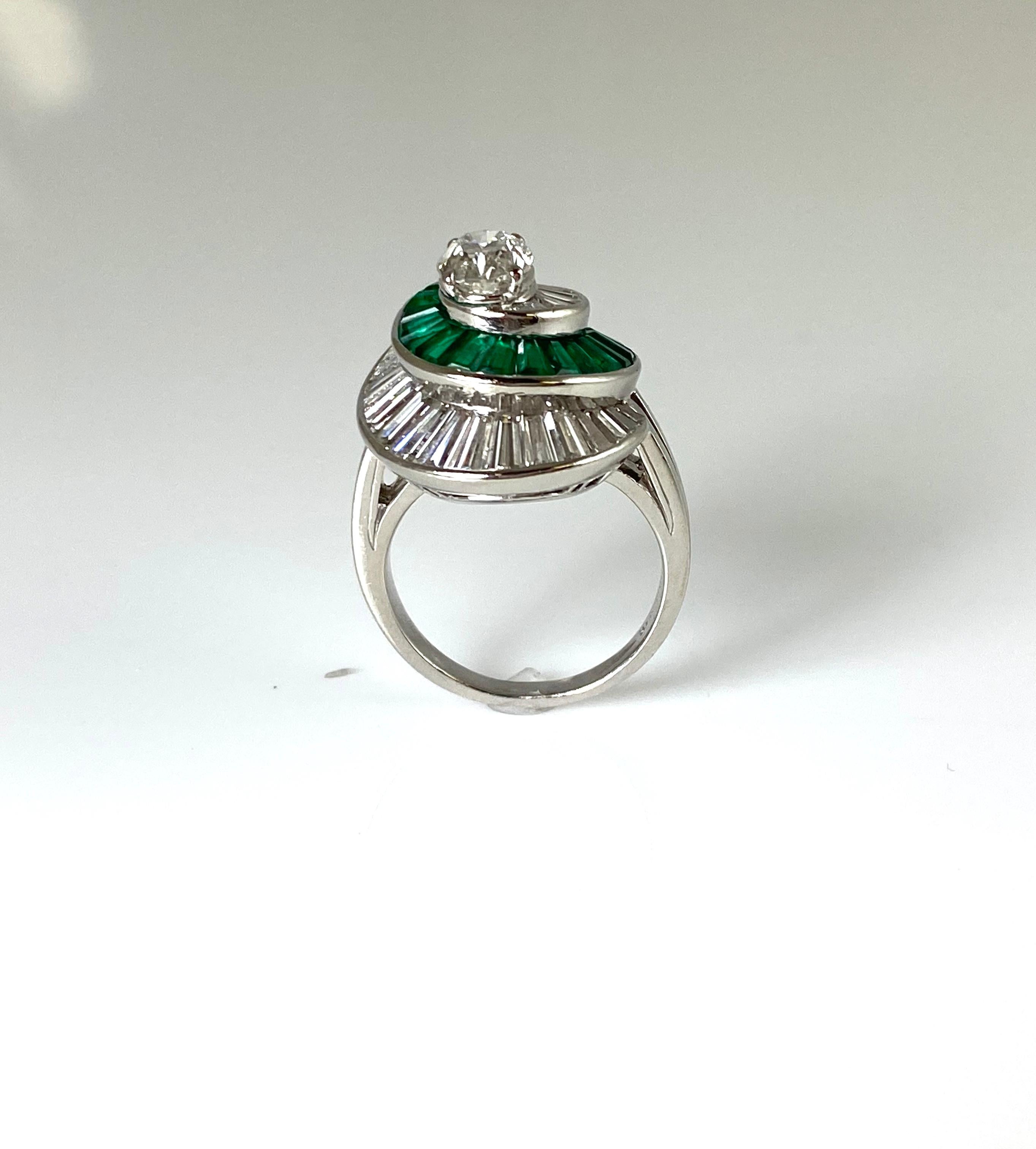 The ring is finely crafted in platinum with oval as center dia weighing approximately total of 0.98.
Emeralds weighing approximately total of 1.62 carat and diamonds weighing approximately total of 1.90 carat.
Numbered by Oscar Heyman .
