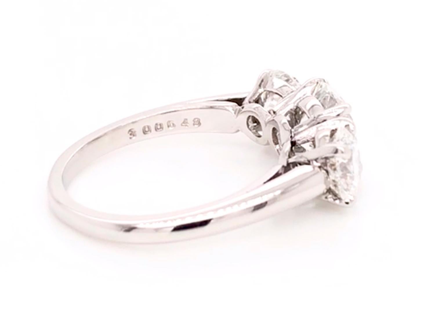 Oscar Heyman platinum round diamond three stone engagement ring contains GIA certified diamonds. The center stone is 1.59cts, H/ VS2 and measures 7.55mm x 4.59mm. The side stones are 0.75cts (H/ VVS2) and 0.77cts (G/VS1). 

It s stamped with the