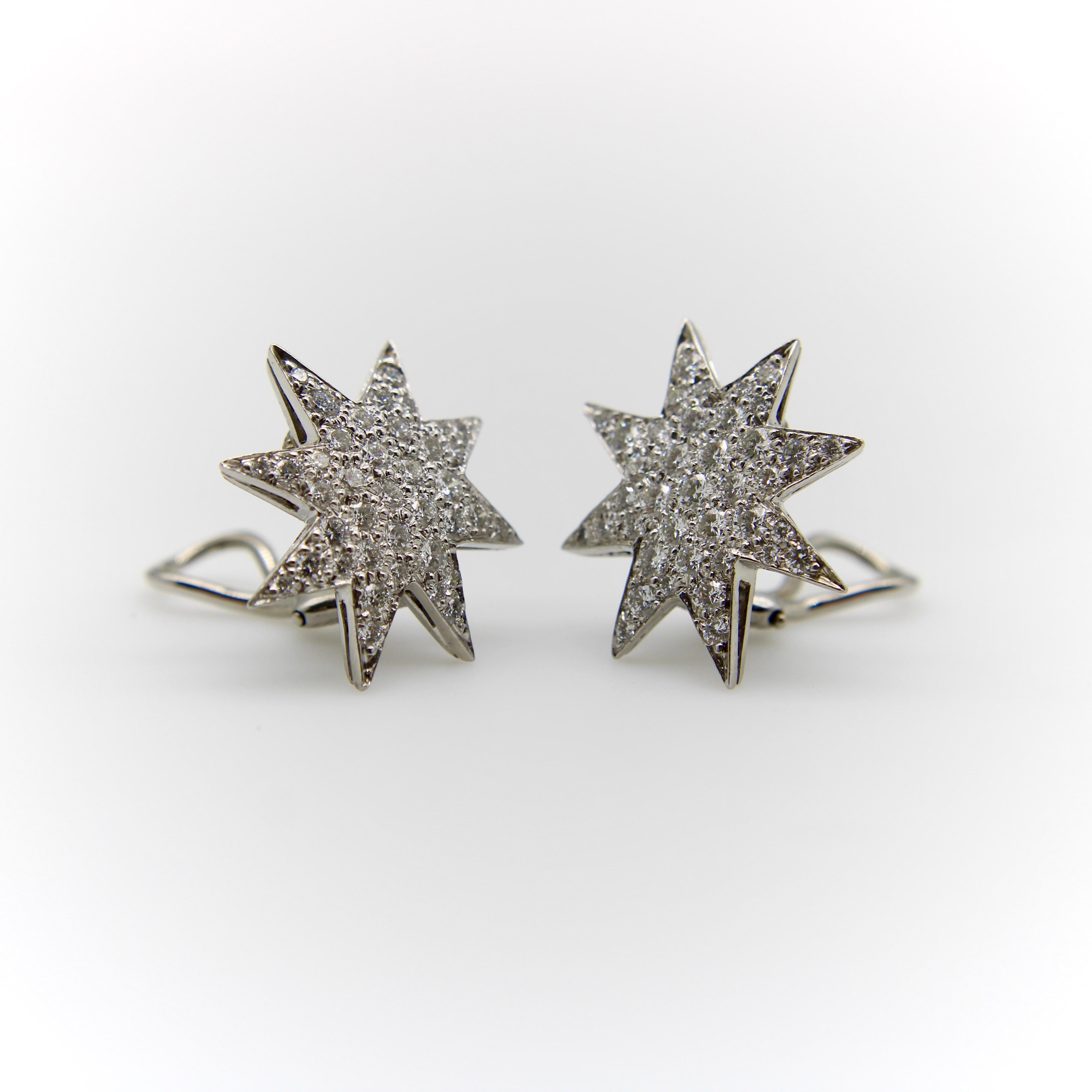 These incredible Oscar Heyman earrings contain pave set diamonds of approximately two carats. The platinum eight-point stars are irregular shapes with longer and shorter points along the star, a non-symmetrical variation resembling a burst of light.