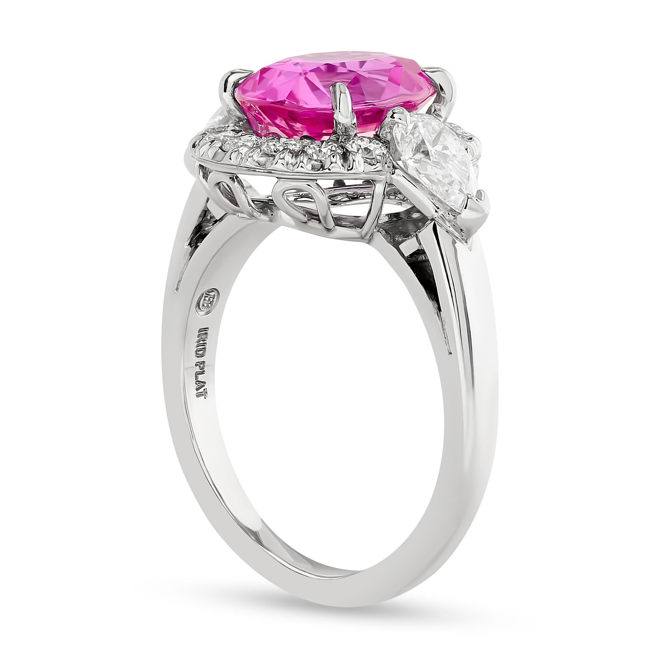 This stunning Oscar Heyman pink sapphire and diamond halo ring is a true masterpiece that captivates with its beautiful craftsmanship.

This ring features one 3.60 carat oval pink sapphire, 2 pear shape and 14 round diamonds totaling approximately