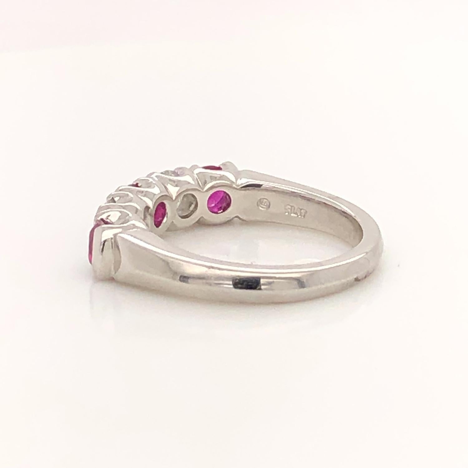 Oscar Heyman platinum ruby and diamond partway wedding band ring contains 2 Round Diamonds (F-G/ VS+ quality) weighing 0.60cts and 3 Round Rubies weighing 0.87cts that are set with partway bezels. This style is very comfortable and secure on the