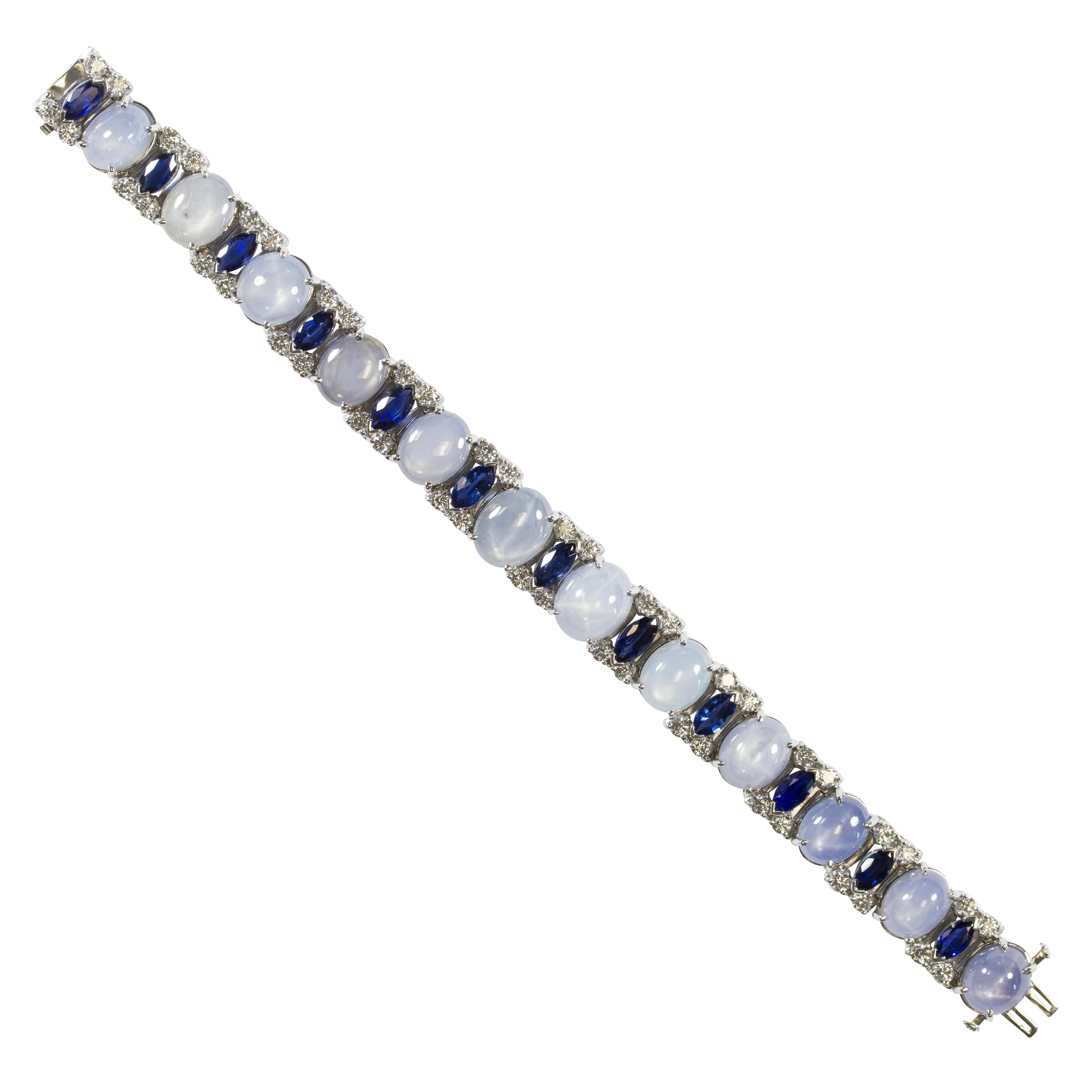 Oscar Heyman platinum bracelet contains 12 Cabochon Ceylon Star Sapphires (87.25tcw, CDC report), 12 Marquise Sapphires weighing 7.82tcw, and 48 Round Diamonds weighing 3.68tcw. It is stamped with the makers mark, IRID PLAT, and serial number