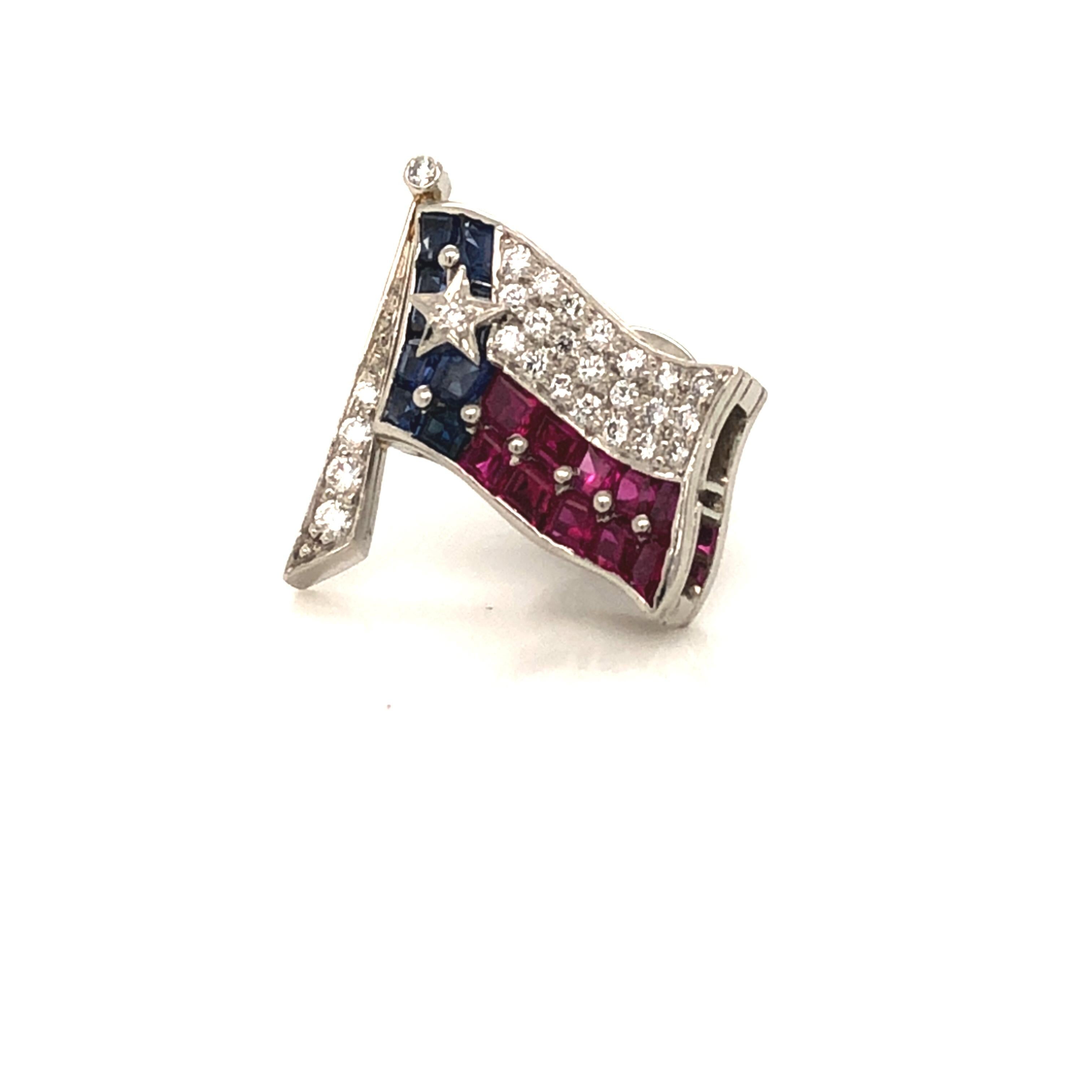 Oscar Heyman platinum Texas Flag lapel pin contains rubies (0.55cts), sapphires (0.54cts) and diamonds (0.21cts). It is stamped with the makers mark, IRID PLAT, and serial number 902816.

Flag pole is 18mm in length, 16mm in width.

Oscar Heyman was