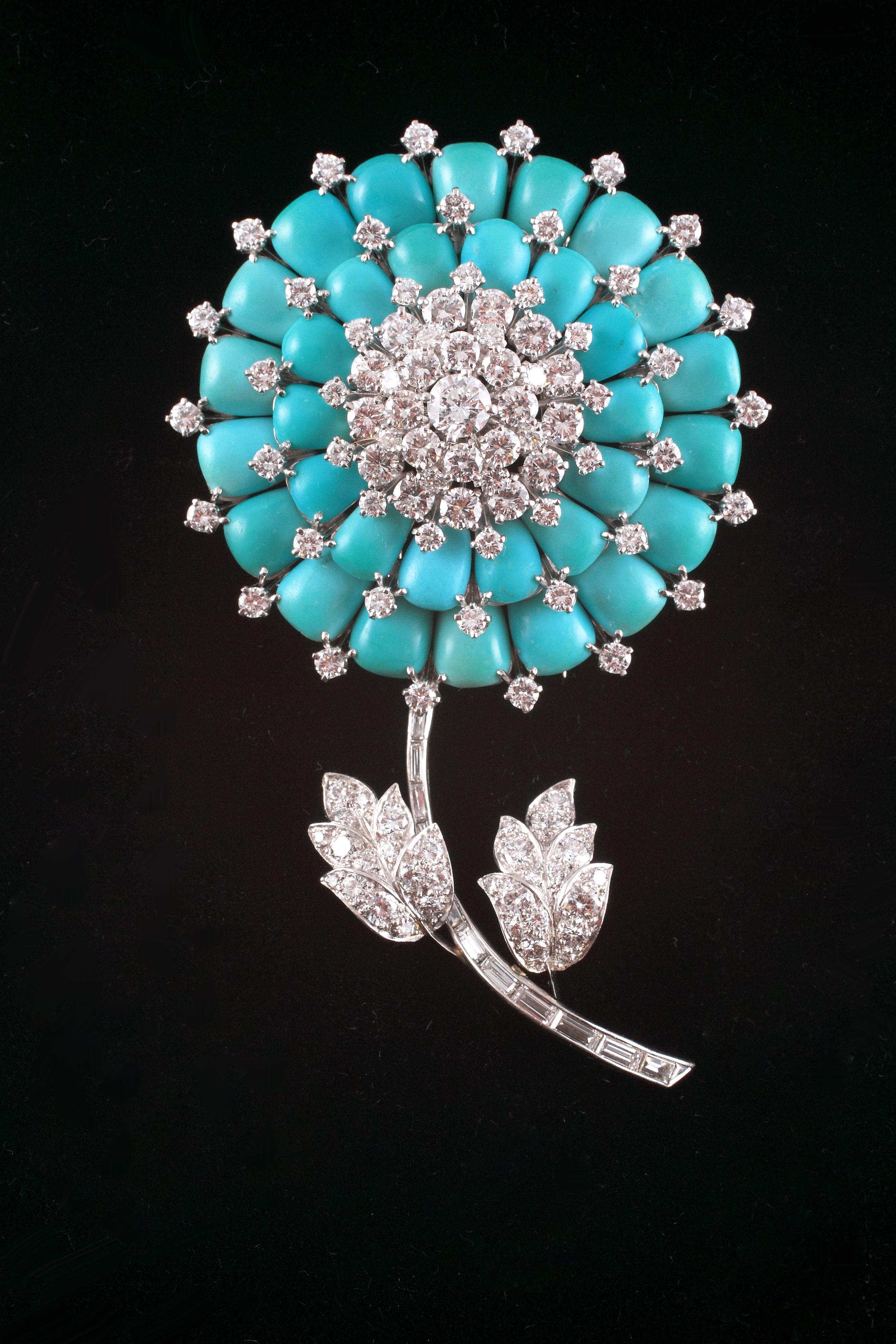 This brooch is absolutely stunning!  Composed of a handmade, platinum mounting, this beauty is accompanied by Certificate of Authenticity from Oscar Heyman, dated November 14, 2018.  The eighteen turquoise petals are beautifully matched and support