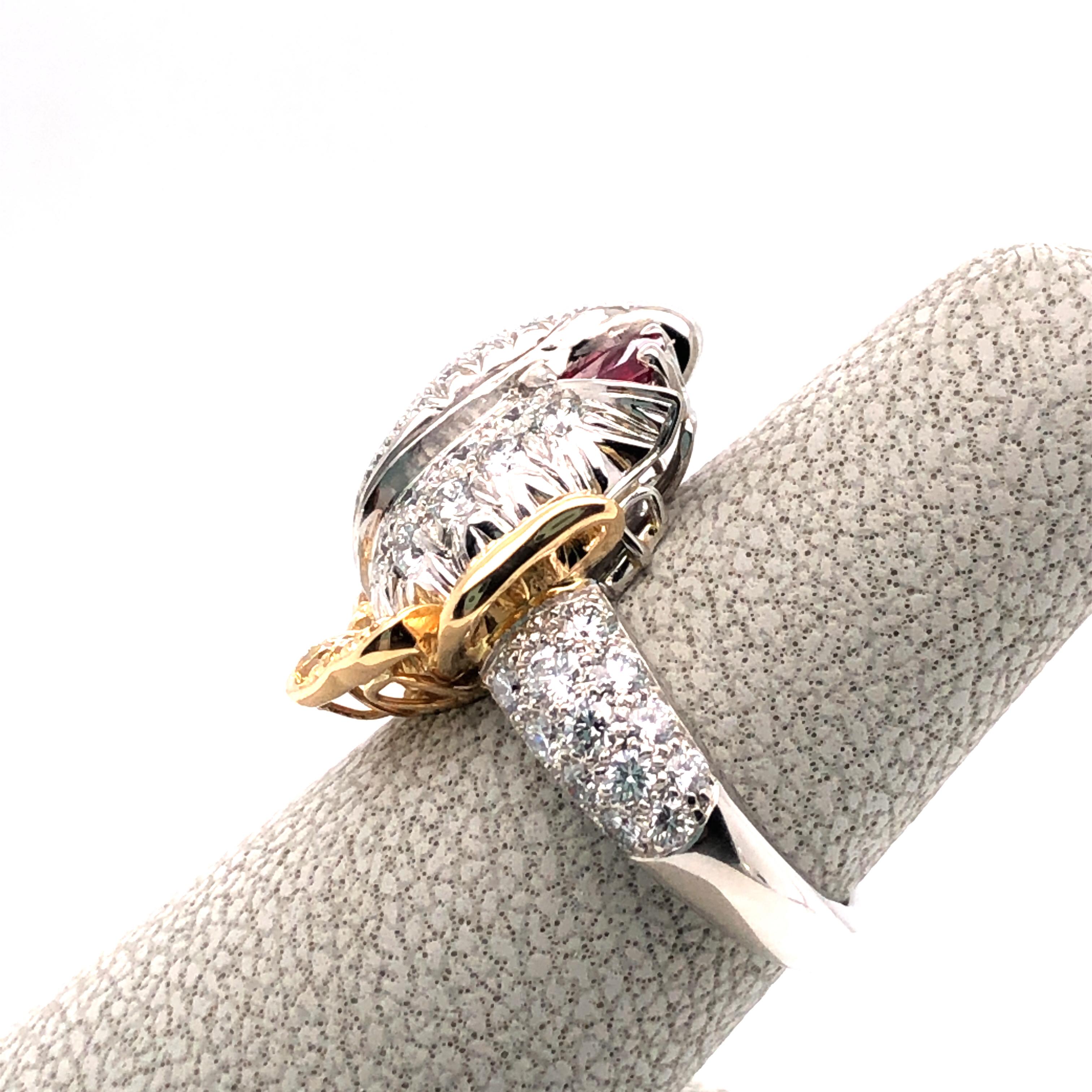 Oscar Heyman platinum and 18kt yellow gold ring contains 1 pear shaped ruby (0.33ct), 54 round diamonds (1.59tcw) and 12 fancy golden yellow diamonds (0.47tcw) . It is stamped with the makers mark, IRID PLAT, and serial number 301645. Rosebud