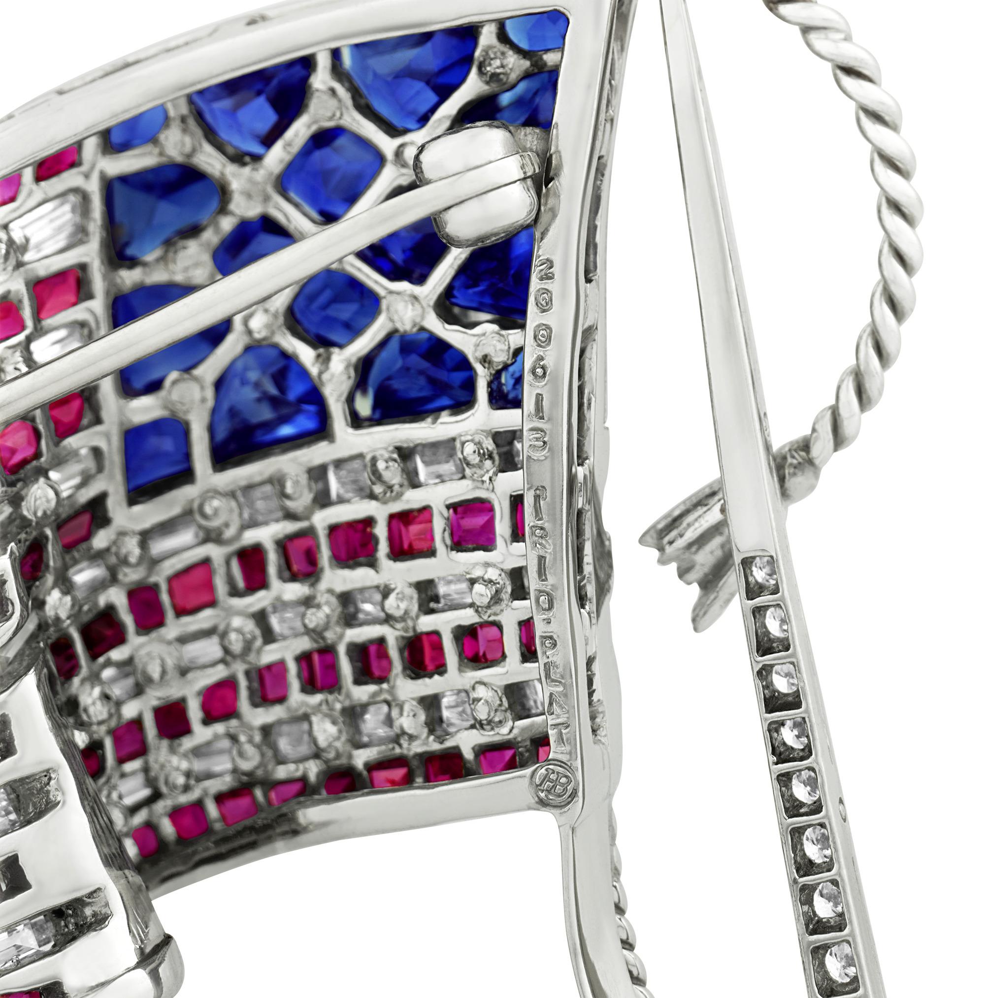 Depicting a waving American flag, this patriotic gemstone creation was crafted by the famed American jeweler Oscar Heyman. Using dozens of sparkling white diamonds, rubies and sapphires, the design brilliantly captures the undulating form of the