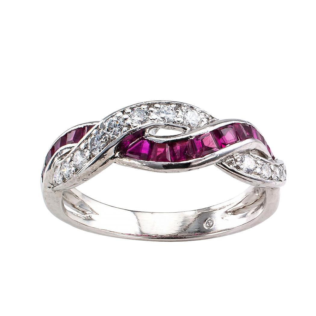 Oscar Heyman ruby diamond and platinum ring band circa 1970. Designed as a pair of braided gem courses, one channel-set rubies; the other bead-set diamonds, the diamonds totaling approximately 0.27 carat, approximately F – G color and VVS-VS