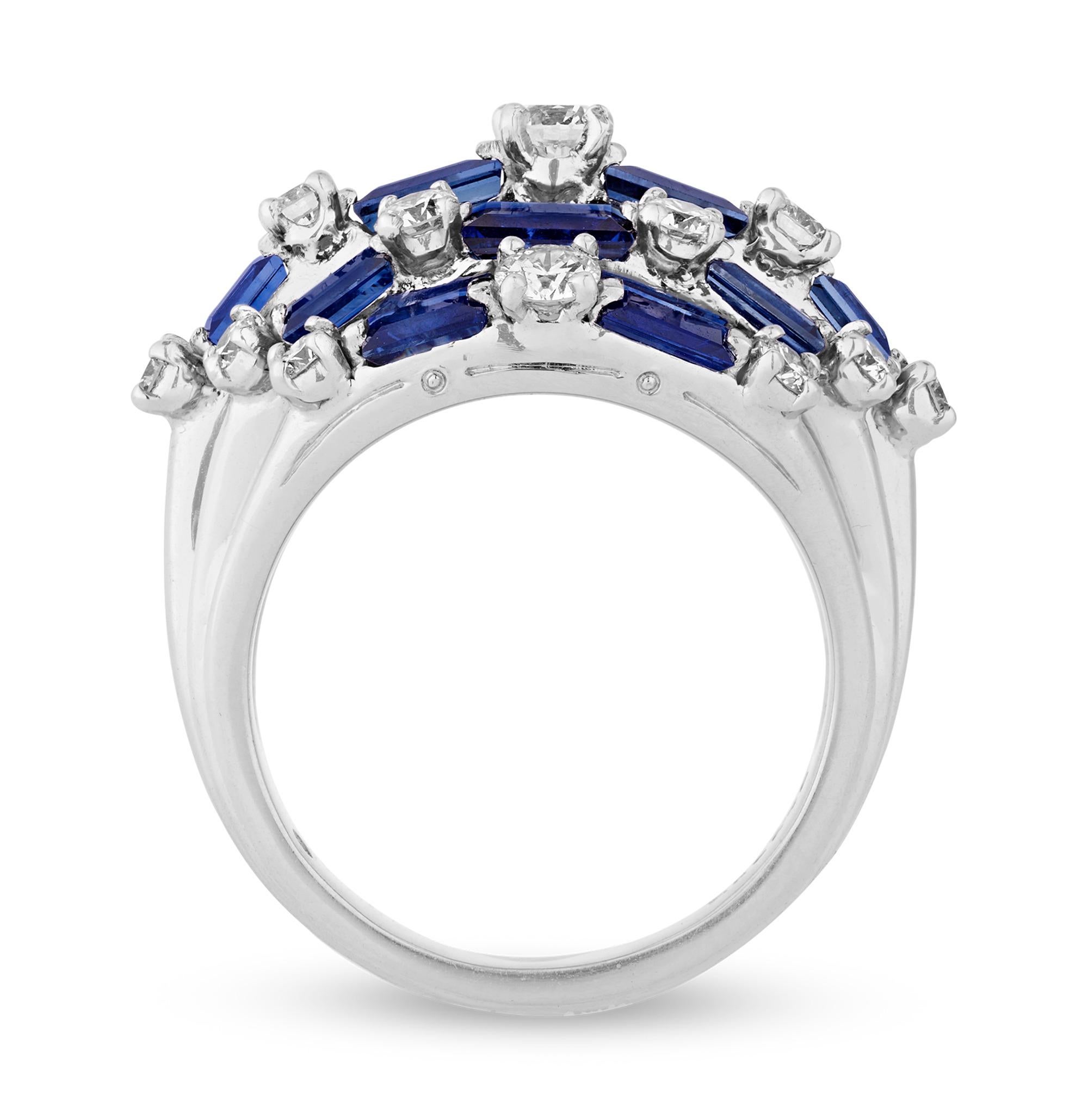 This bombe-style ring by the esteemed Oscar Heyman features baguette cut sapphires totaling 3.68 carats accented by round diamonds totaling 1.28 carats. The unique design weaves the sapphires and diamonds together to create a stunning statement