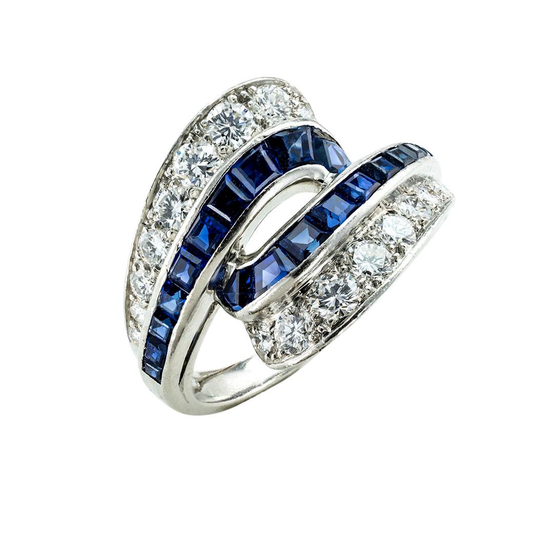 Oscar Heyman sapphire diamond and platinum ring circa 1950. *

SPECIFICATIONS:

GEMSTONES:  graduating, calibrated blue sapphires.

DIAMONDS:  eighteen round brilliant-cut diamonds totaling approximately 0.90 carat, approximately F-G color, VS