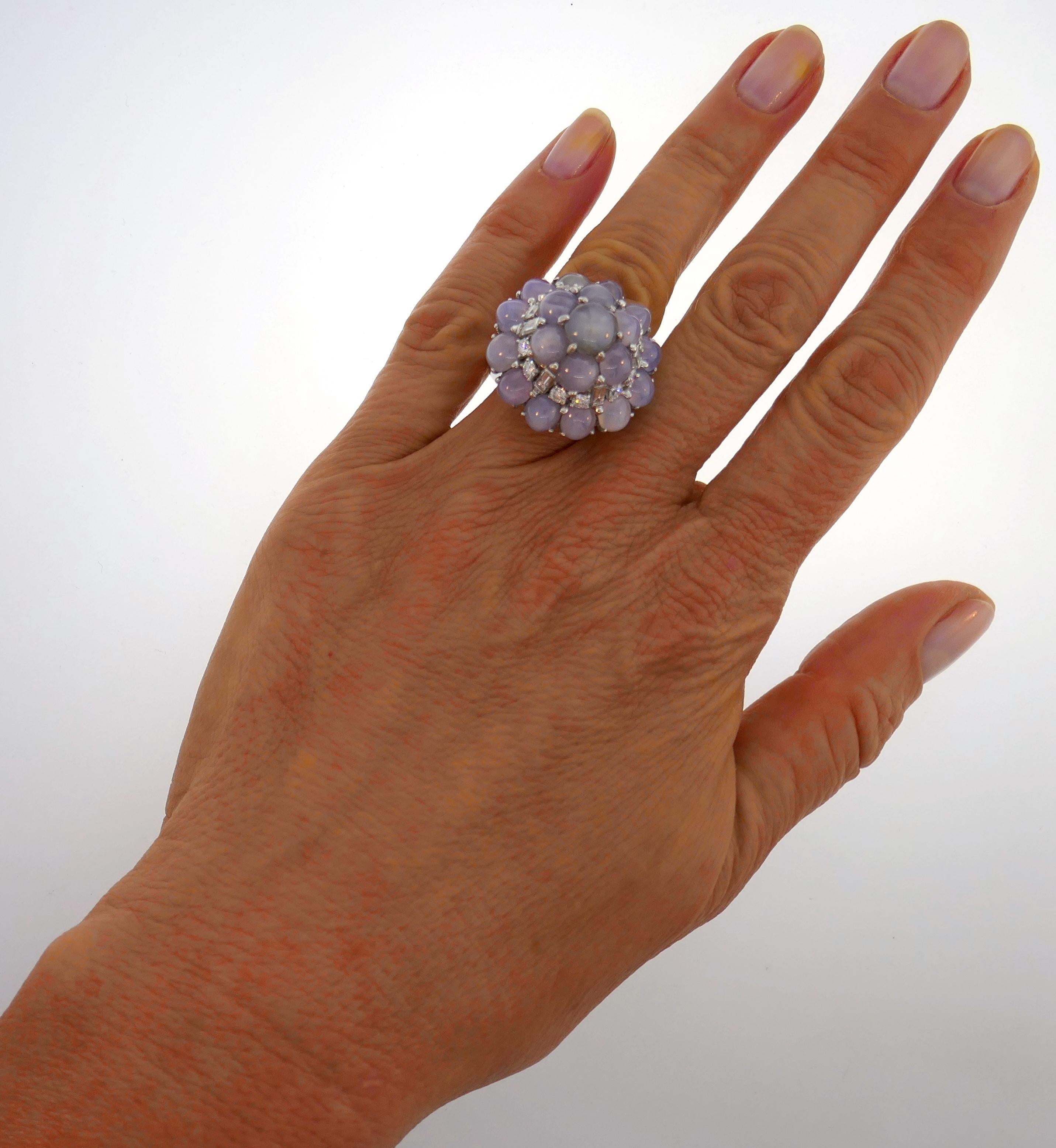 Classy and timeless cocktail ring created by Oscar Heyman in the 1960s. Elegant and wearable, the ring is a great addition to your jewelry collection. 
The ring is made of platinum and features nineteen cabochon star sapphires (total weight 25.45