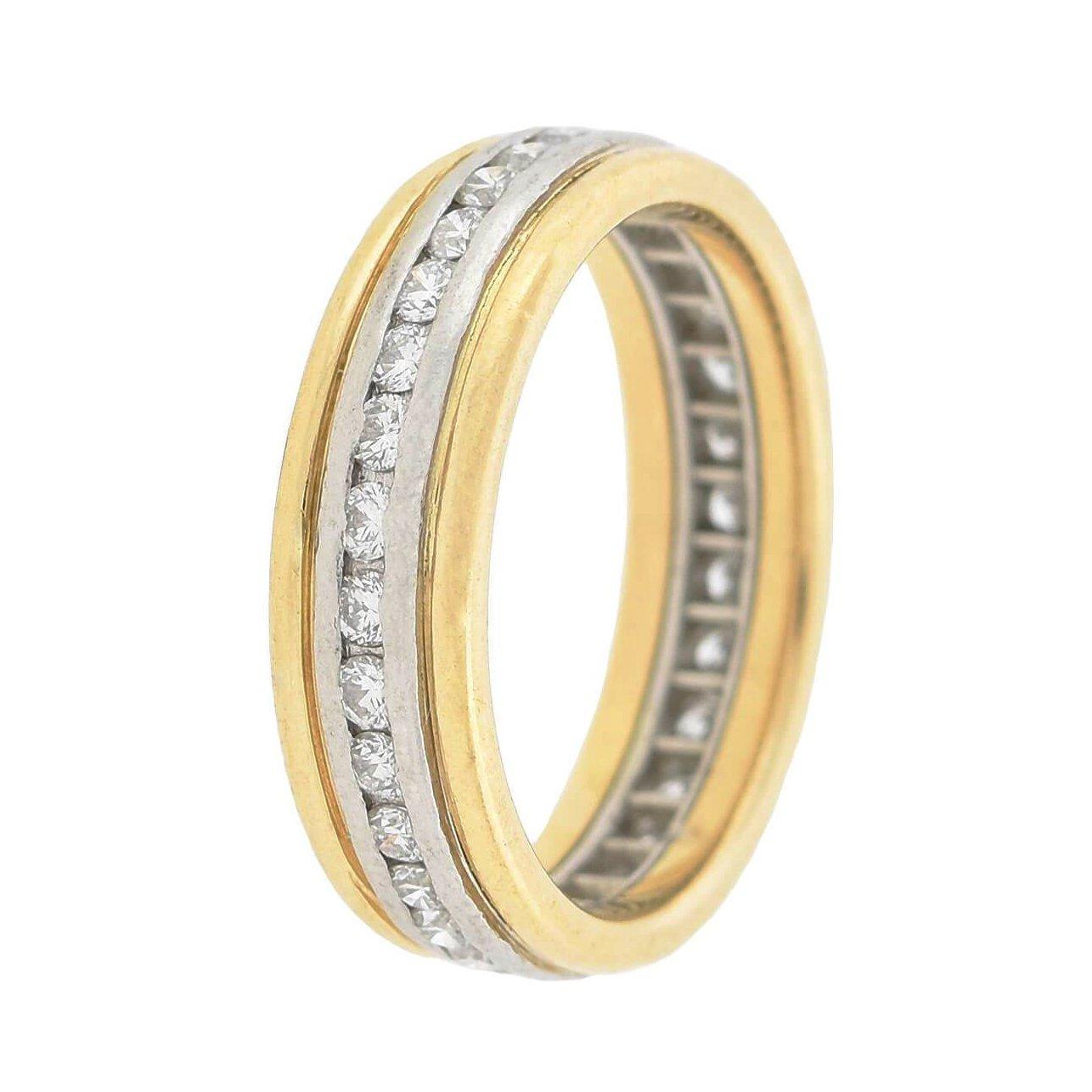 This beautiful ring is a signed piece by renowned designer Oscar Heyman! The stylish mixed metals band is crafted in 18kt yellow gold and platinum and exhibits a beautiful 2-tone appeal. The wide surface displays a gorgeous platinum center row