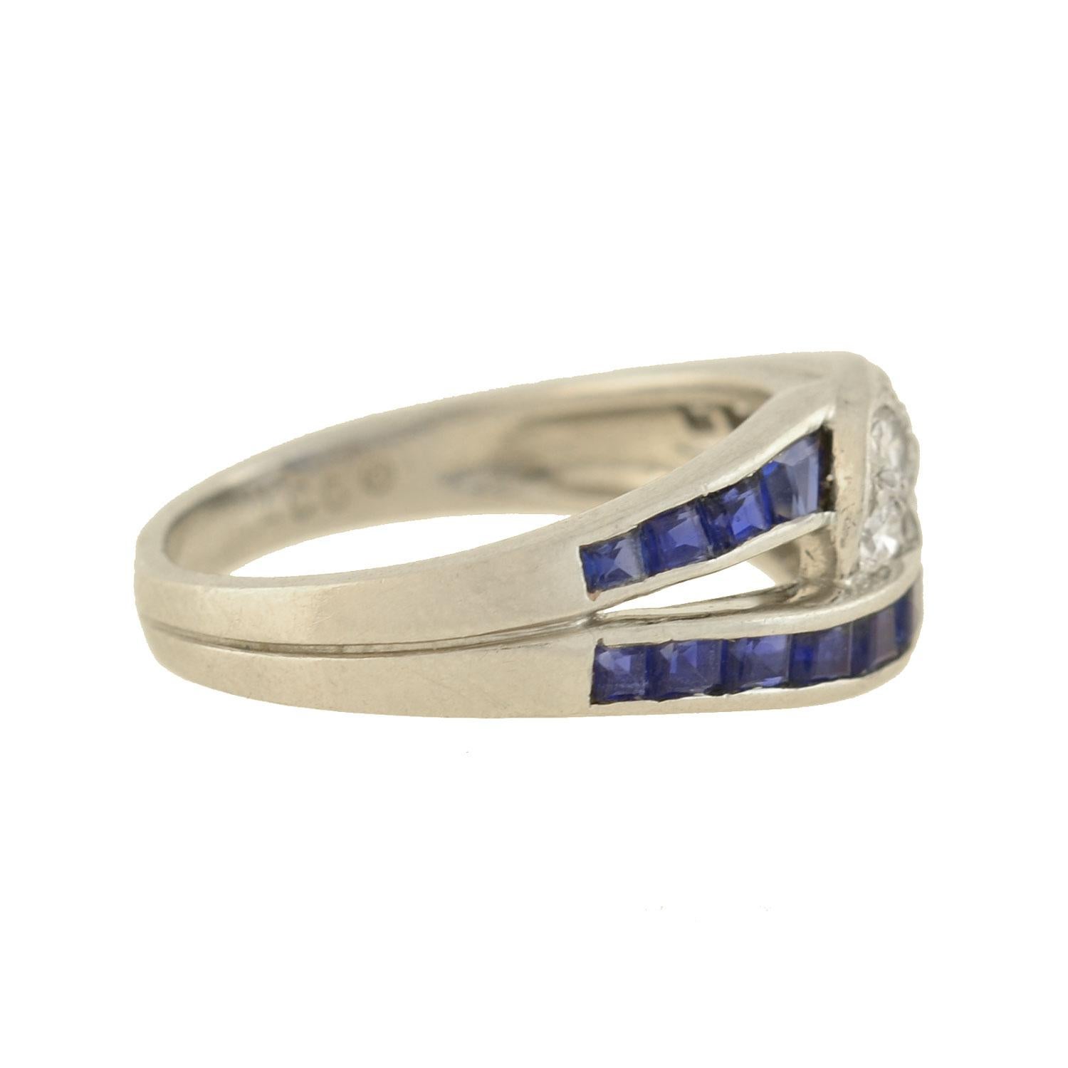 This beautiful vintage ring from the 1960s is a designer piece signed by reknowned maker Oscar Heyman! Crafted in platinum, this piece is comprised of two elongated interlocking links, one encrusted with diamonds and the other adorned with