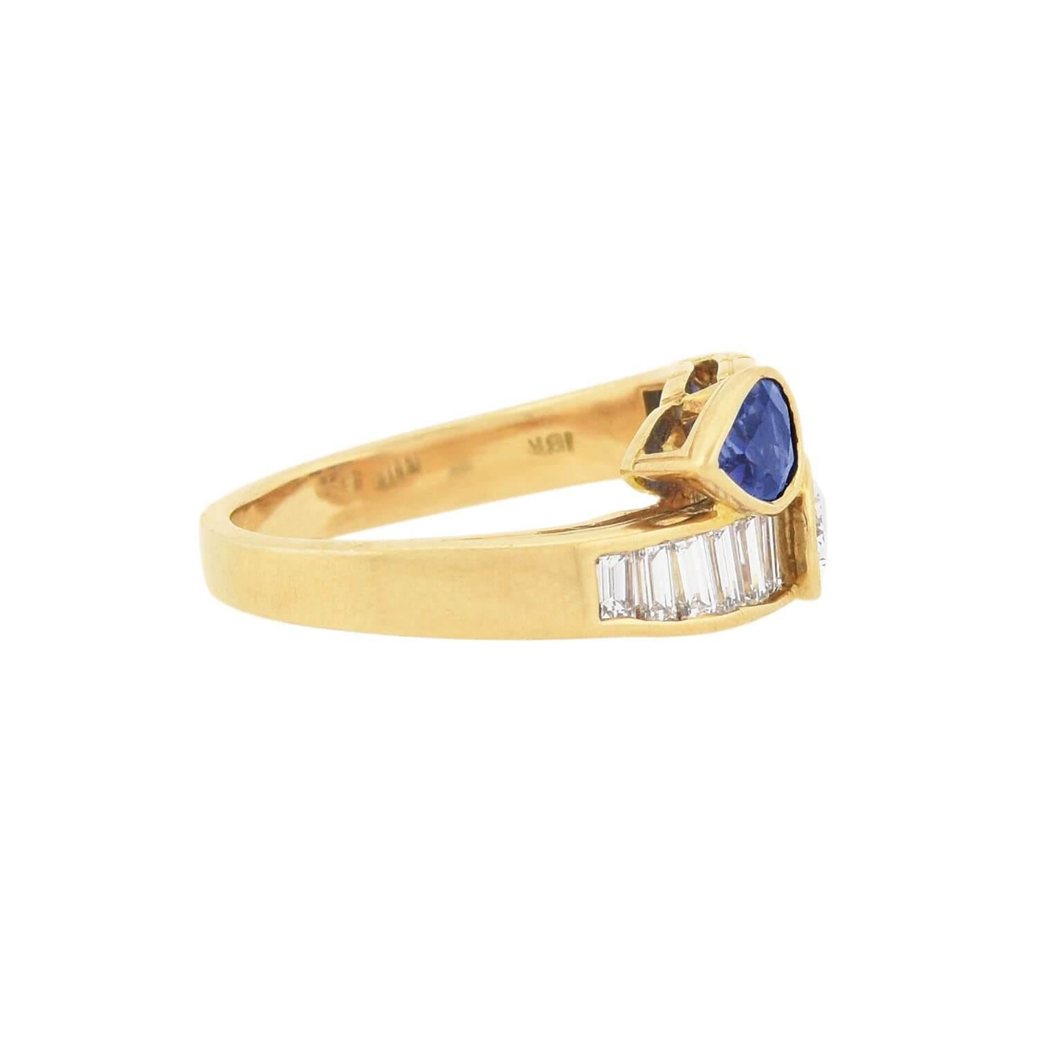 This beautiful vintage ring from the 1960s is a designer piece signed by Oscar Heyman! Crafted in 18kt gold, the ring features a row of diamonds and sapphires nestled together, forming a stylish bypass design. Two pear cut stones rest at the center,