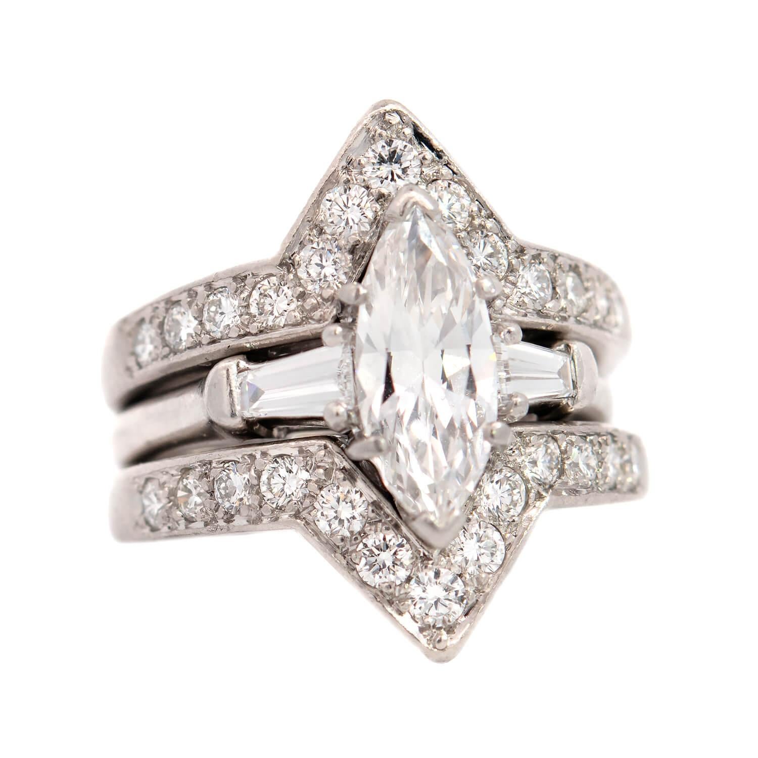 A gorgeous vintage diamond engagement ring with two fitted ring guards from the 1960s by legendary designer OSCAR HEYMAN! This unique trio of rings is composed of platinum, and the central marquise diamond in the engagement ring weighs 1.00ct with G