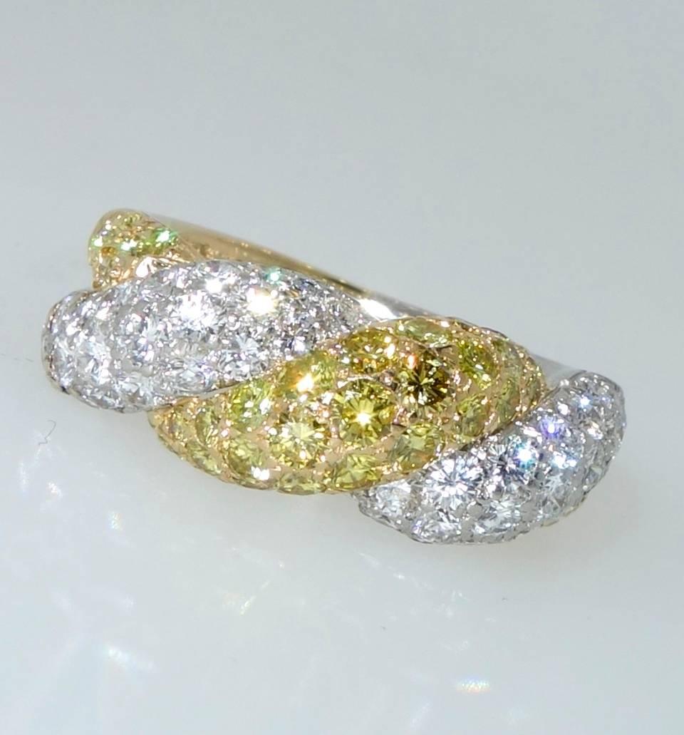 Oscar Heyman the famous American jewelry house has hand made this ring with very fine diamonds.  The vivid yellow diamonds weigh approximately 1.12 cts., and the white (F) color diamonds weigh 1.20 cts.  The ring is both platinum and 18k yellow