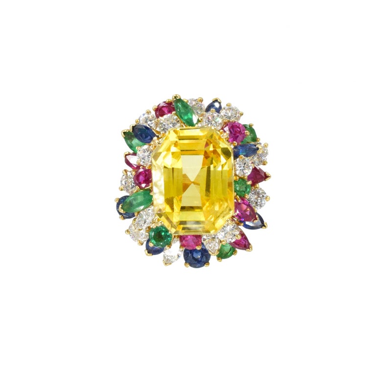 Oscar Heyman Yellow Sapphire, Colored Stone and Diamond Ring in 18k white
gold. Center of the ring set with GIA certified emerald-cut yellow sapphire with total weight of 22.53ct. GIA report no. 1111180 stating that the yellow sapphire is of Ceylon