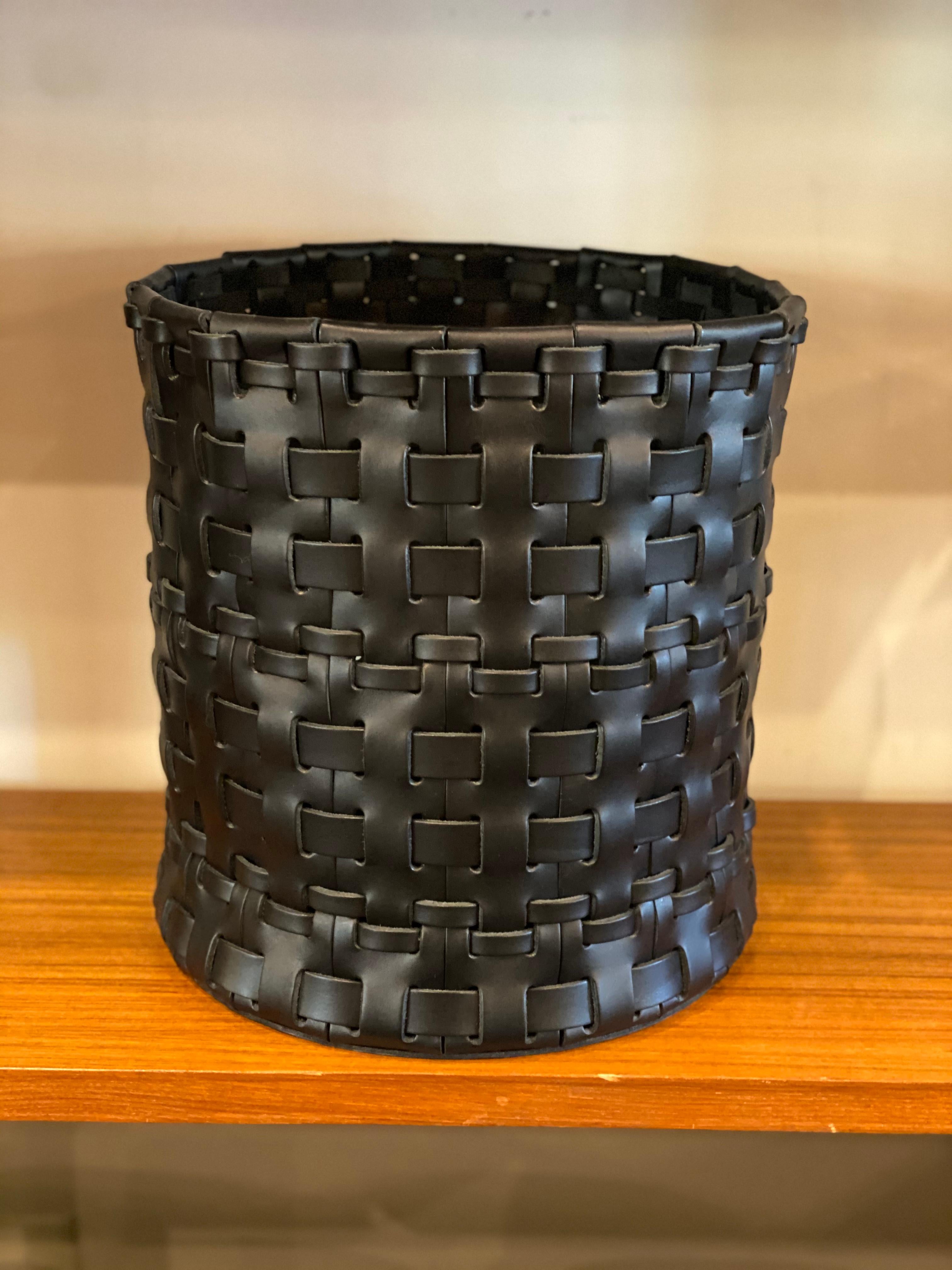 Handmade woven leather wastebasket by Oscar Maschera. Three baskets available in color elm and one available in black.

Artist turned artisan, Oscar Maschera exclusively uses genuine Italian leather, treated with natural extracts and dyed in