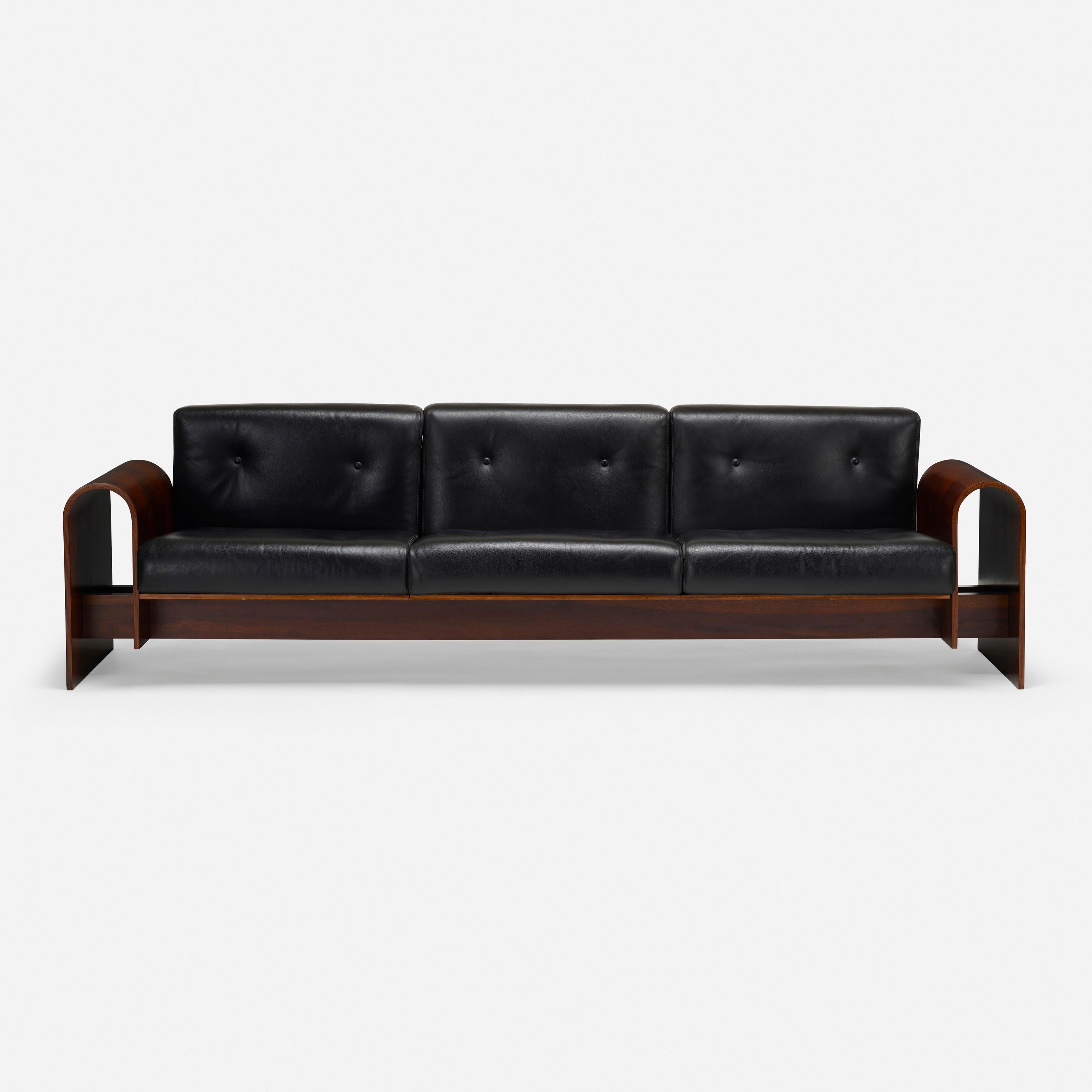 Oscar Niemeyer (1907 - 2012)

A rare, three-seat sofa by Oscar Niemeyer for the SESC Hotel Copacabana in Rio de Janeiro; in Brazilian rosewood with black leather cushions. A model of modernist sensuality that makes remarkable use of Niemeyer’s