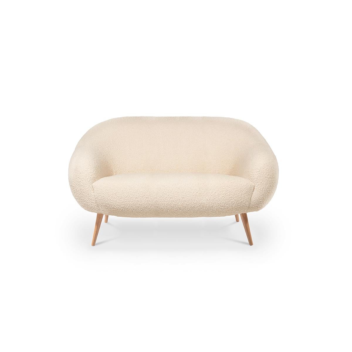 The rounded lines of this early 1950s style armchair are influenced by the 