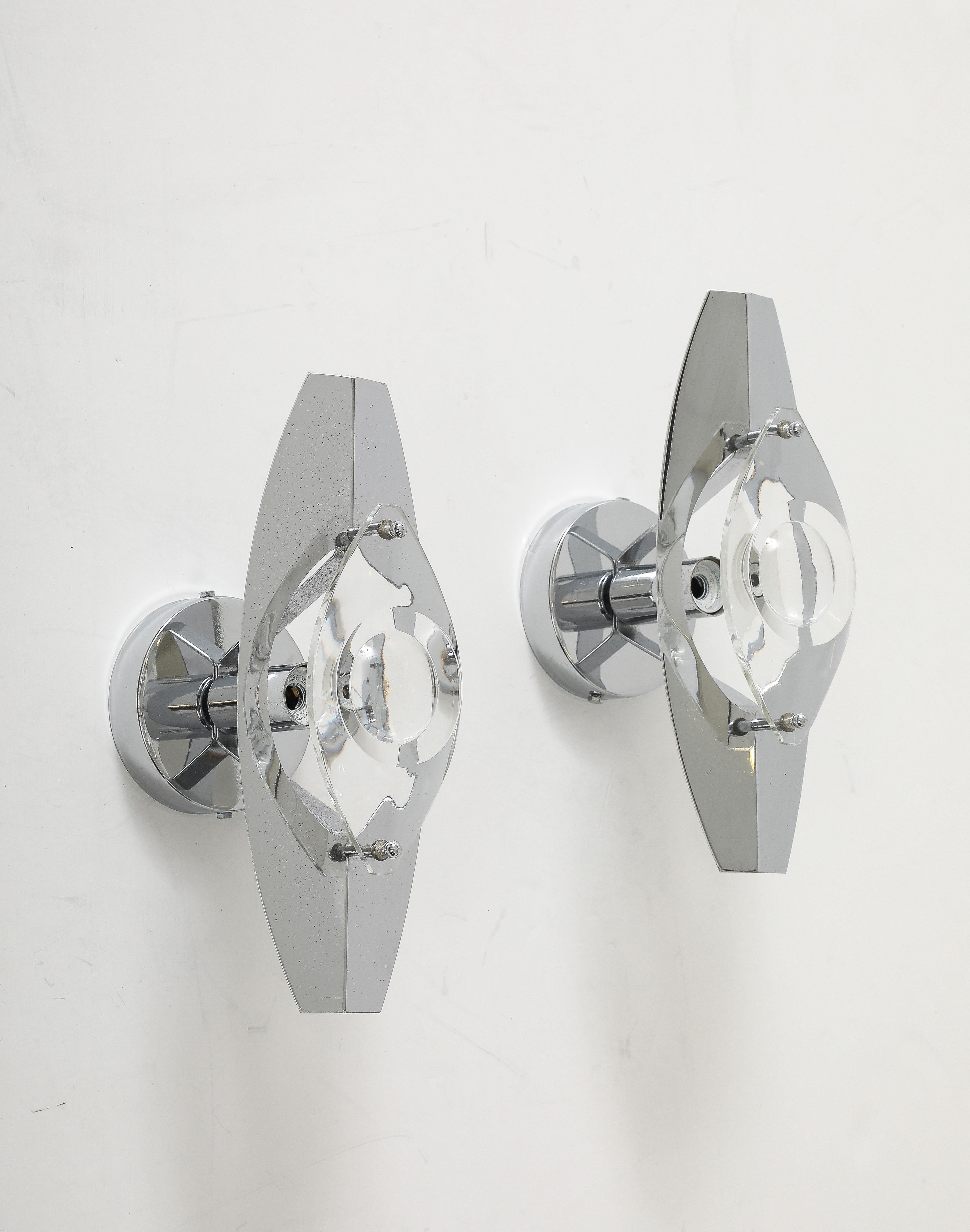 Pair of Italian Mid Century chrome sconces featuring an optic lens with a convex center. Sconces have been professionally polished and rewired for use in the USA.