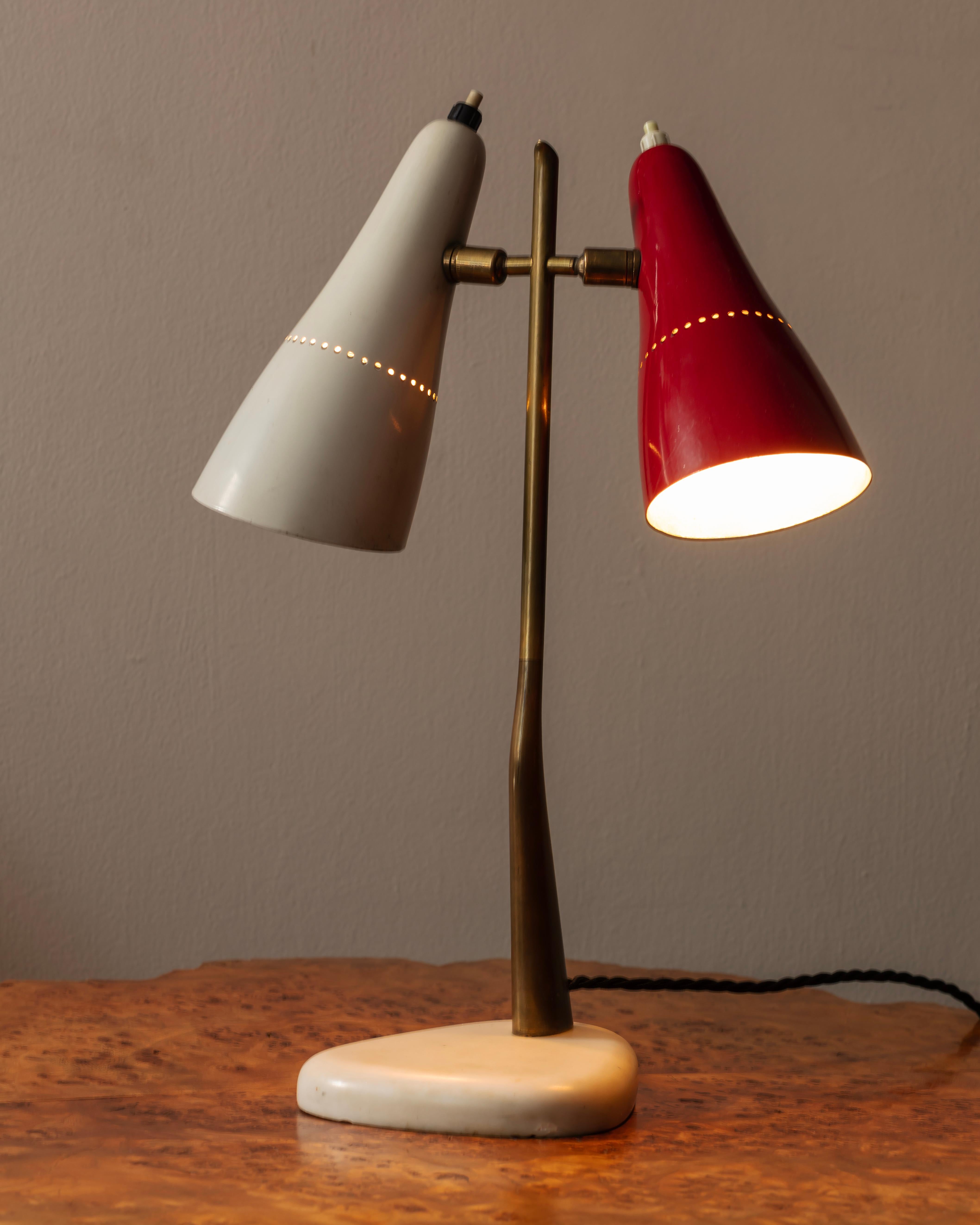 Double headed desk lamp, red and cream enamel lampshades on an elegant brass upright and marble base. Excellent original condition. A rare design confidently attributed to Oscar Torlasco proably for Lumi, Milan. Rewired to UK standards with