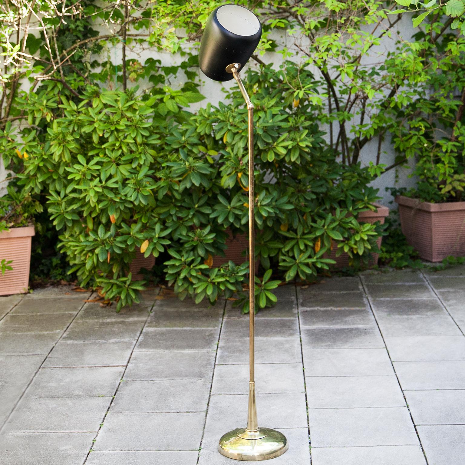 Adjustable floor lamp attributed to Oscar Torlasco, Italy 1960s.

The floor lamp was executed in brass and with a black metal shade, two E27 sockets.