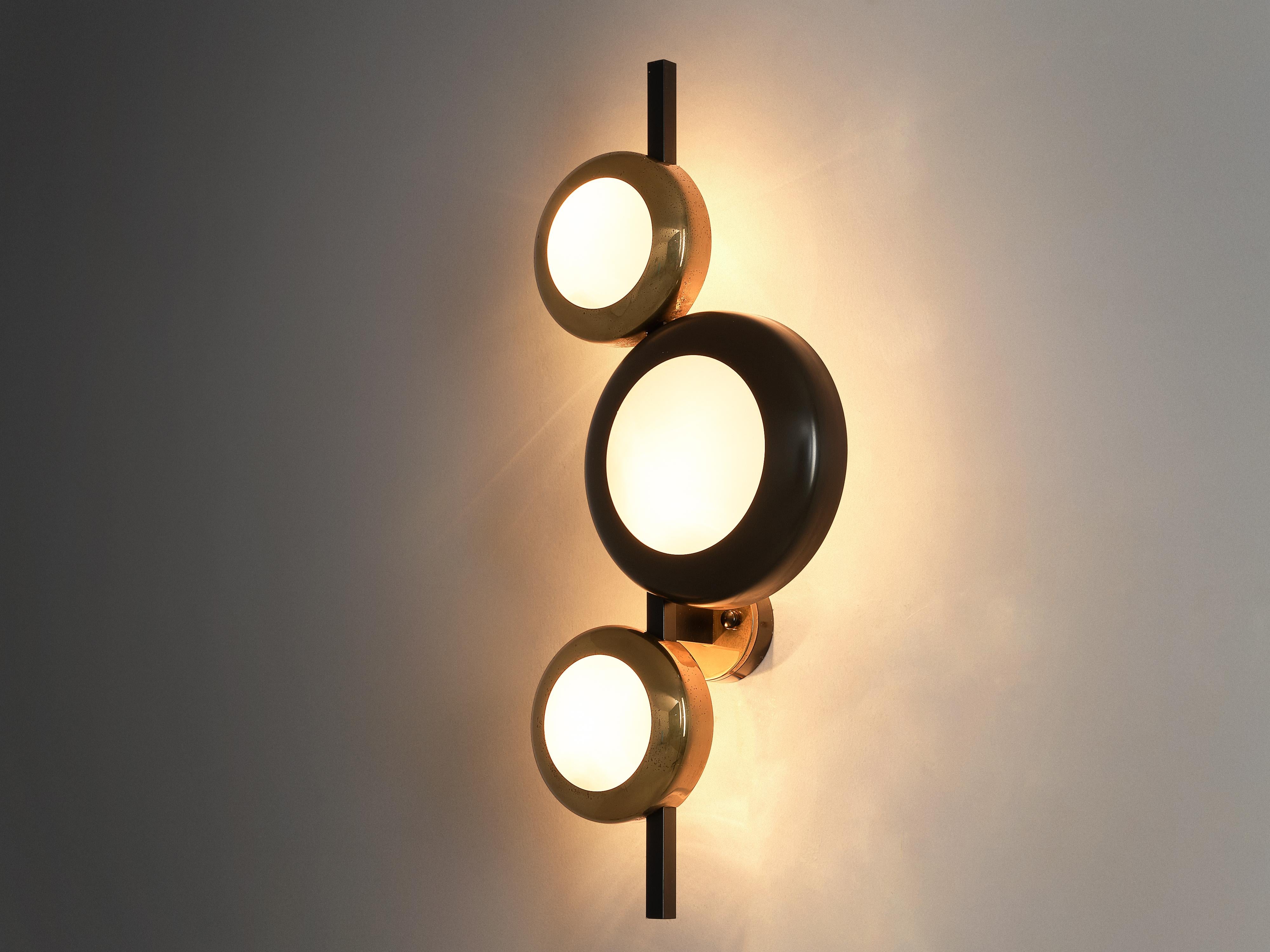 Oscar Torlasco for Lumi Milano, wall lamps, brass, glass, metal, Italy, 1950s

Admirable wall lamp by Italian designer Oscar Torlasco, manufactured by Lumi Milano. This playful lamp is designed of three round shades that open towards the wall. One