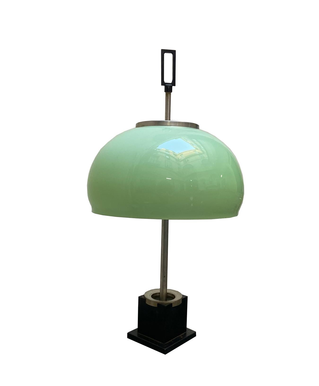 Table lamp with a nickel-plated metal construction and an iron cast base lacquered in black.
The reflector is made of opaline green-colored glass.