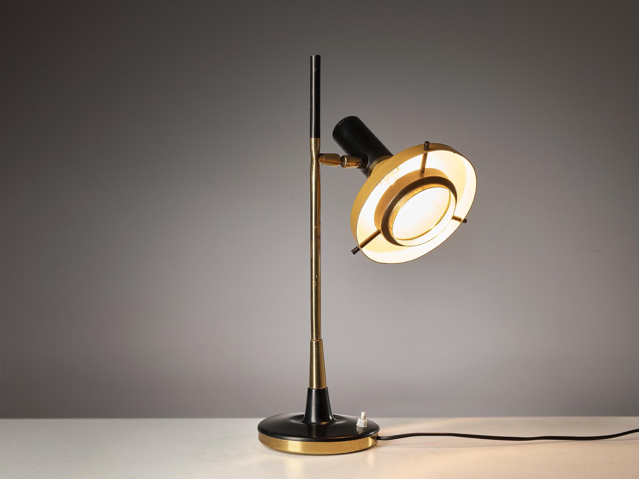 Oscar Torlasco, table lamp '553', metal, brass, Italy, 1950s.

Refined small desk light by Italian designer Oscar Torlasco for Lumi. The light consists of a round base in black coated metal with a bottom in brass. The stem is also executed in