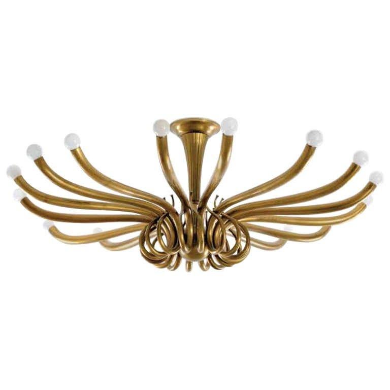 A large brass ceiling fixture with multiple curvaceous arms by Oscar Torlasco.

Italian, Circa 1960's