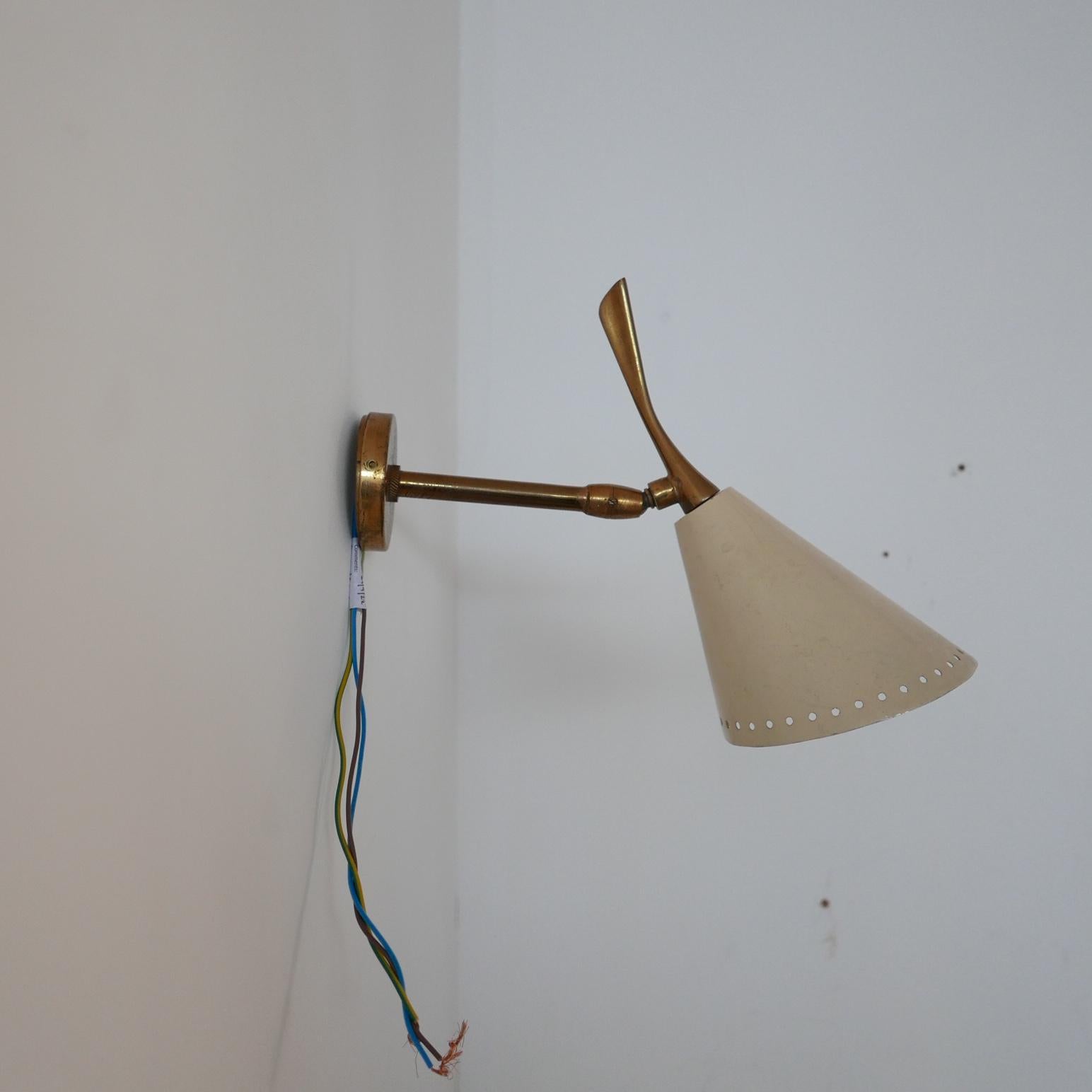 A single wall light by Oscar Torlasco for Lumen. 

Italy, c1960s. 

D12 sconce. 

Enameled aluminium and brass. 

Adjustable Directional shade. 

Original paint, some paint wear but they can be re-sprayed if requested. 

Since re-wired