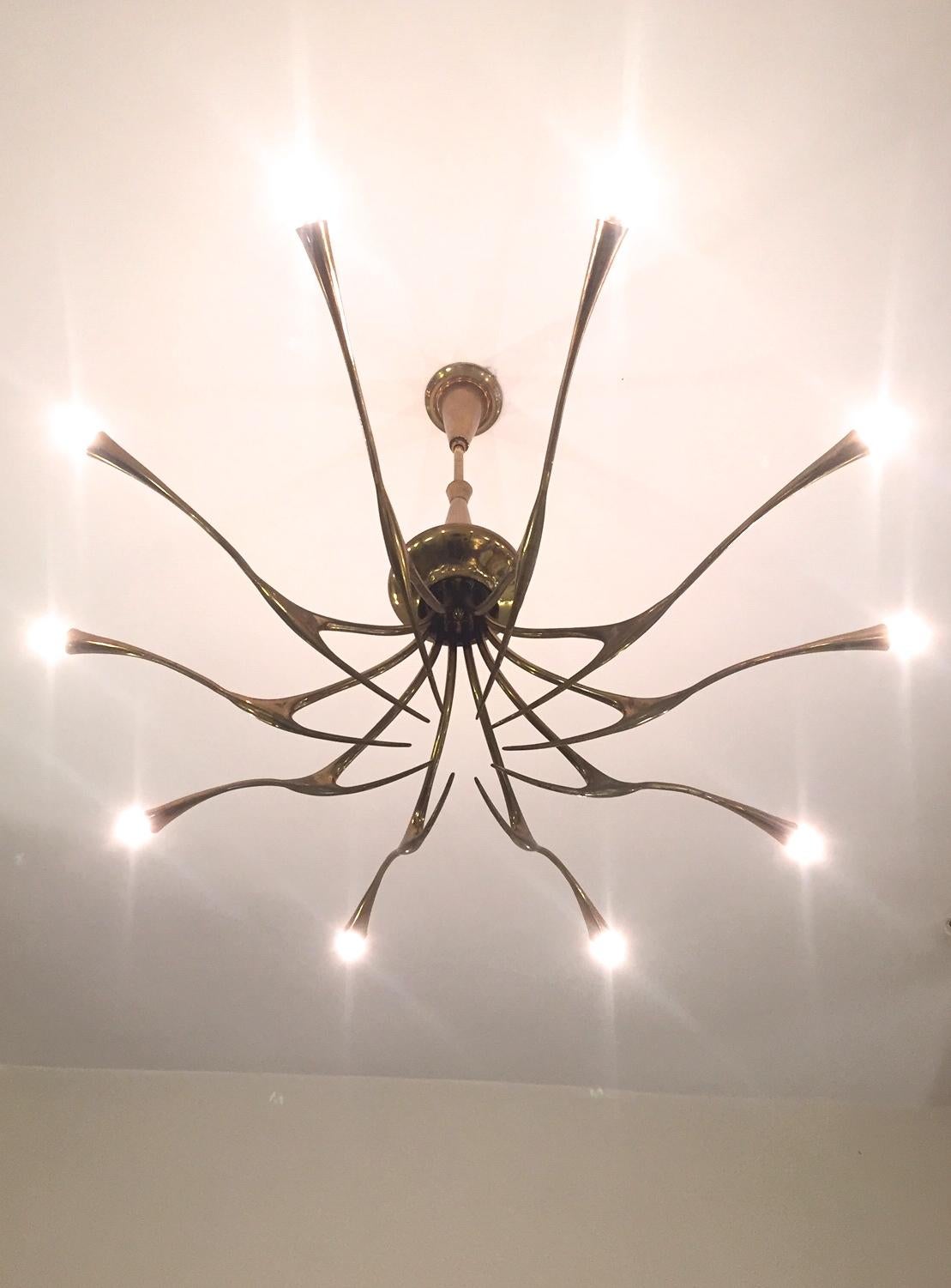 A brass ten armed chandelier designed by Oscar Torlasco for Lumi in the 1950s. Excellent condition.