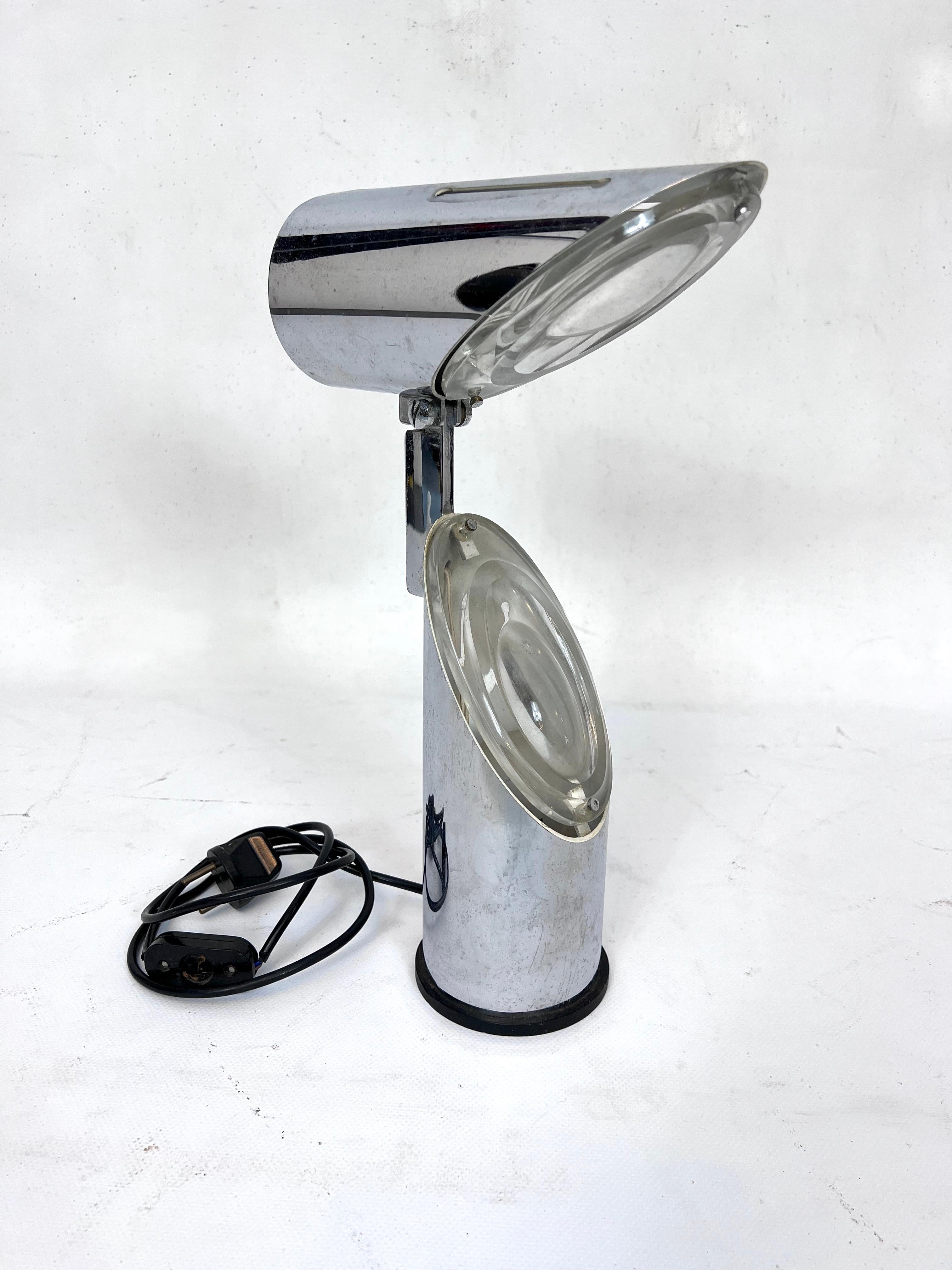 Space age style adjustable table lamp made from chromed metal and glass. Designed by Oscar Torlasco and produced by Stilkronen during the 60s. Normal Vintage condition with trace of age and use. Glass with some small chips near the screws. Full